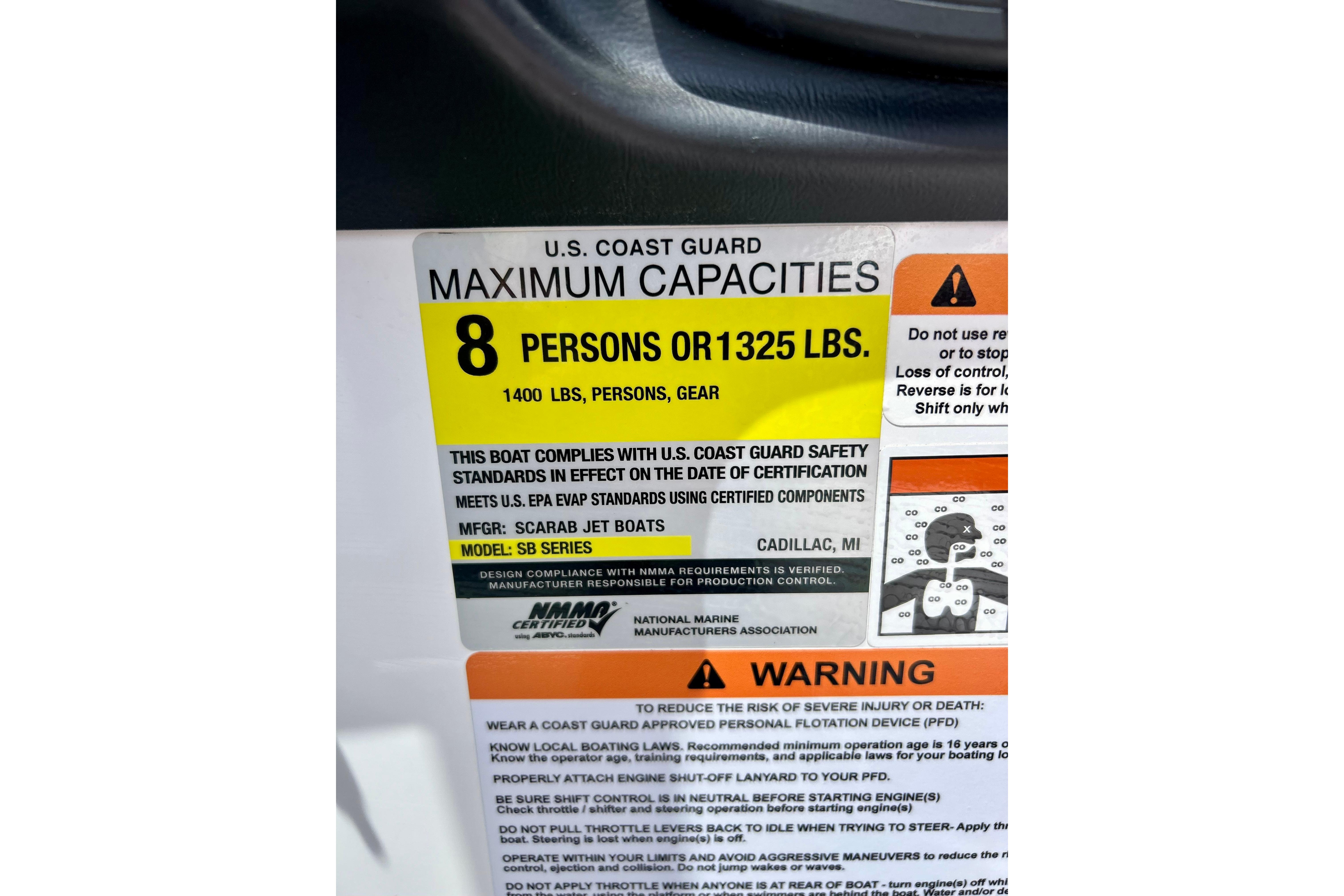 Scarab 195 ID 2021 boat capacity label, 8 persons or 1325 lbs, safety warnings included.