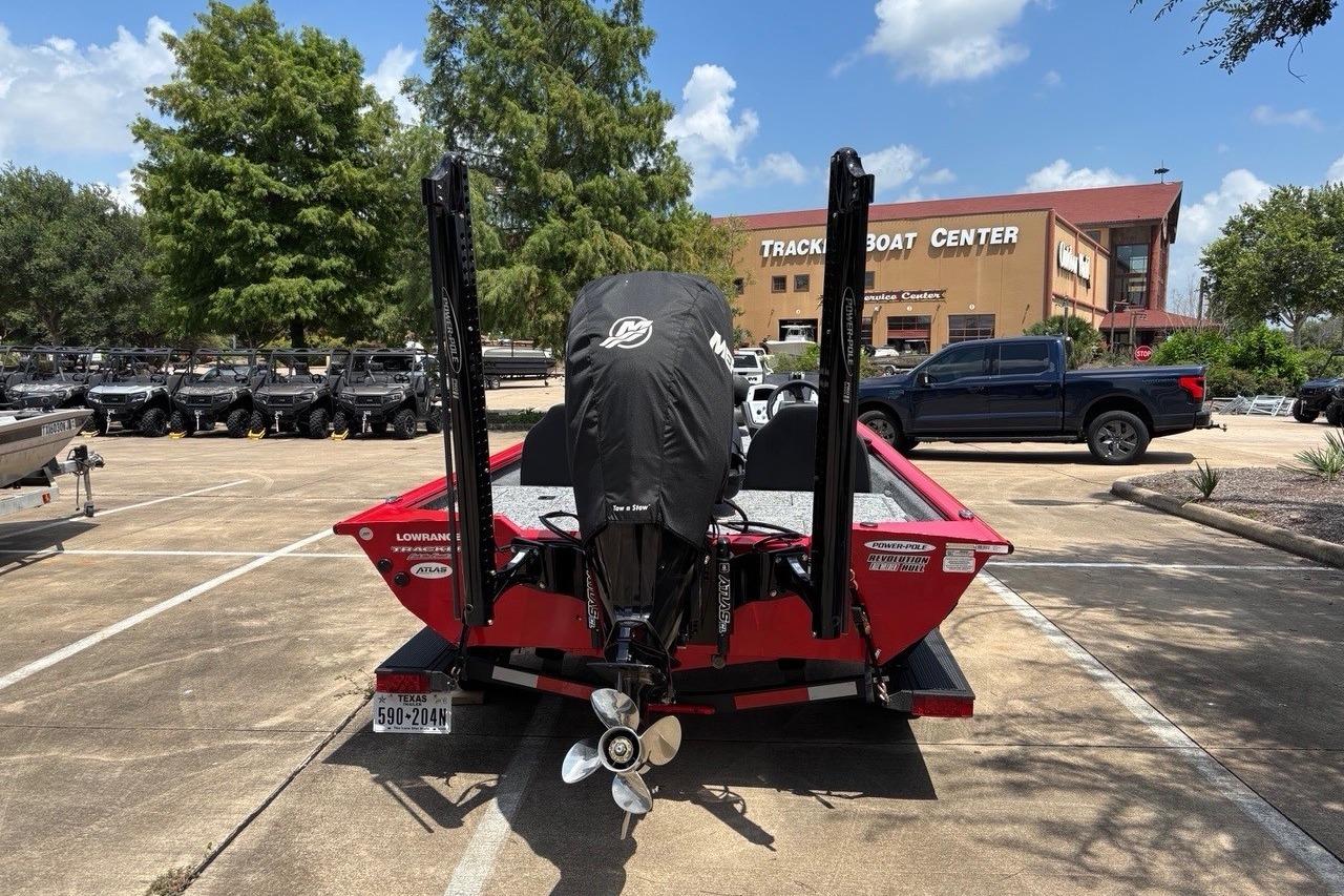 2026 Tracker Pro Team 190 TX boat at dealership parking lot, rear view.
