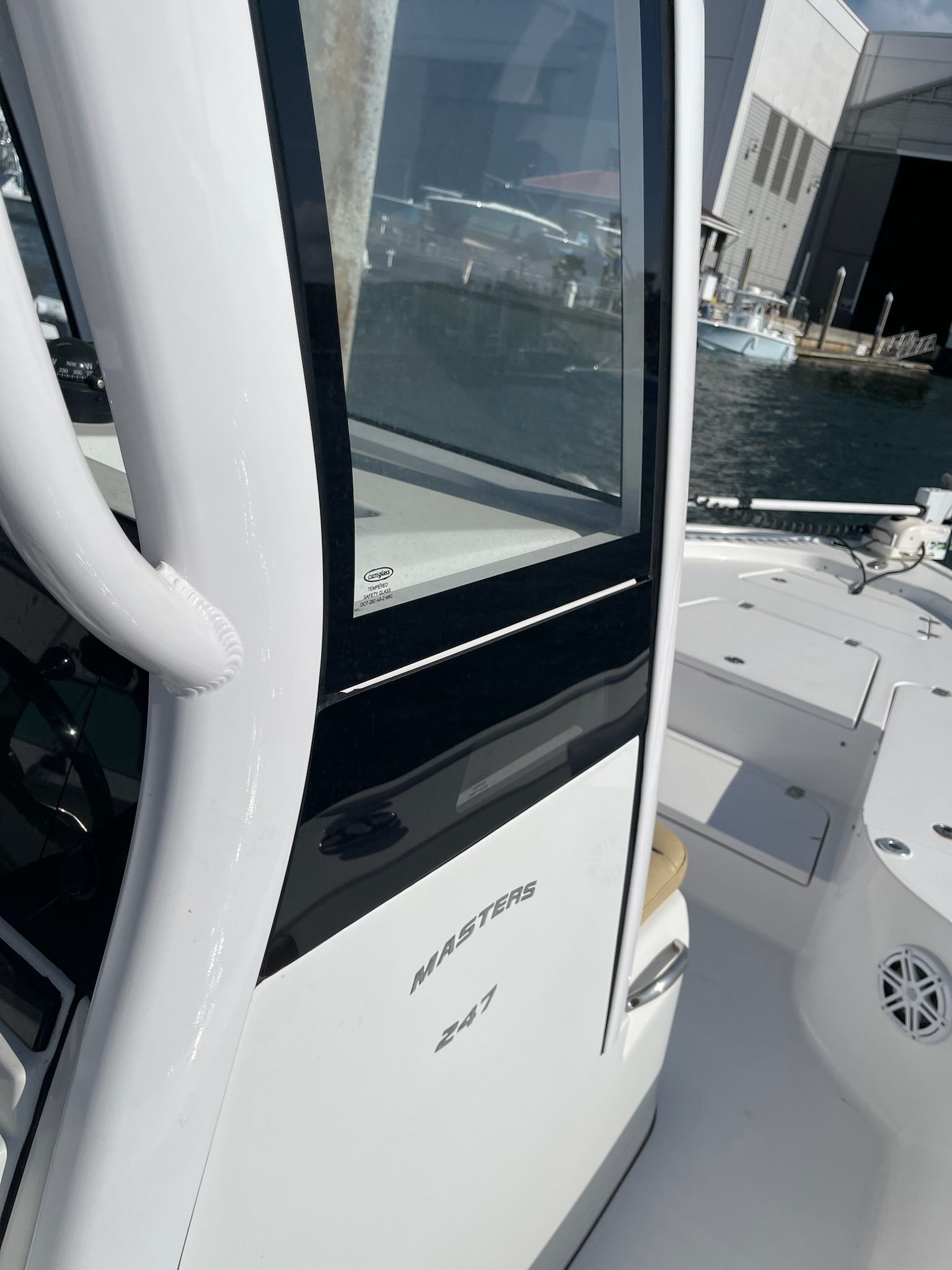 A 2022 Sportsman Masters 247 Bay Boat is docked. View of the cockpit area.