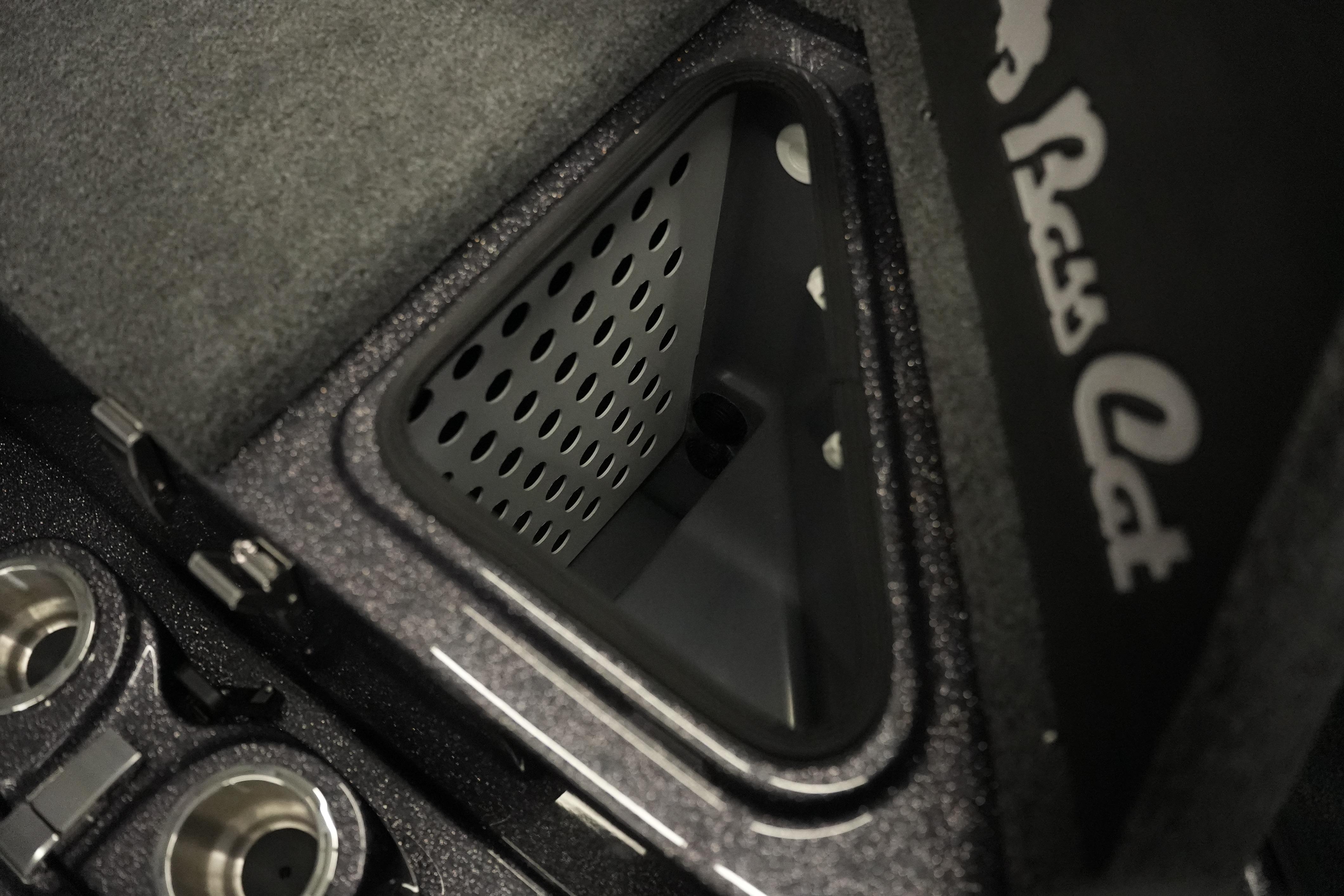 2026 Bass Cat Puma STS interior storage compartment with cup holders and carpeted finish.