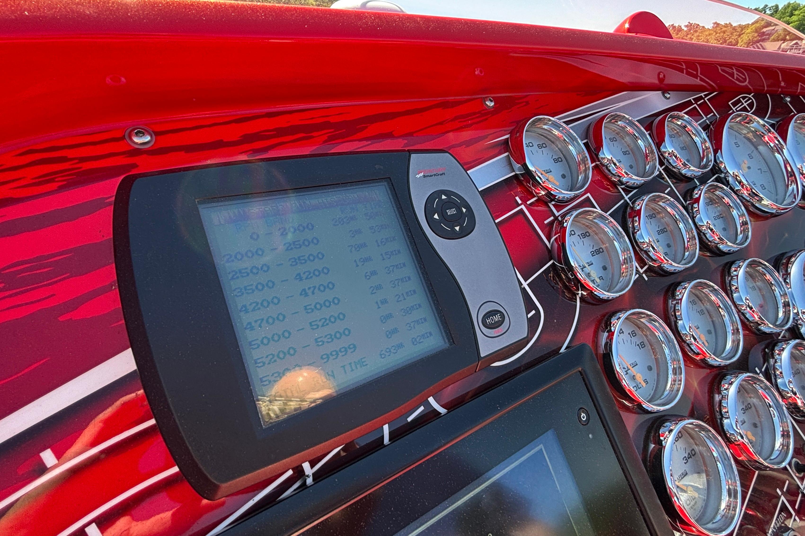 Dashboard of a 2004 Outerlimits 42 Legacy boat with gauges and digital display.