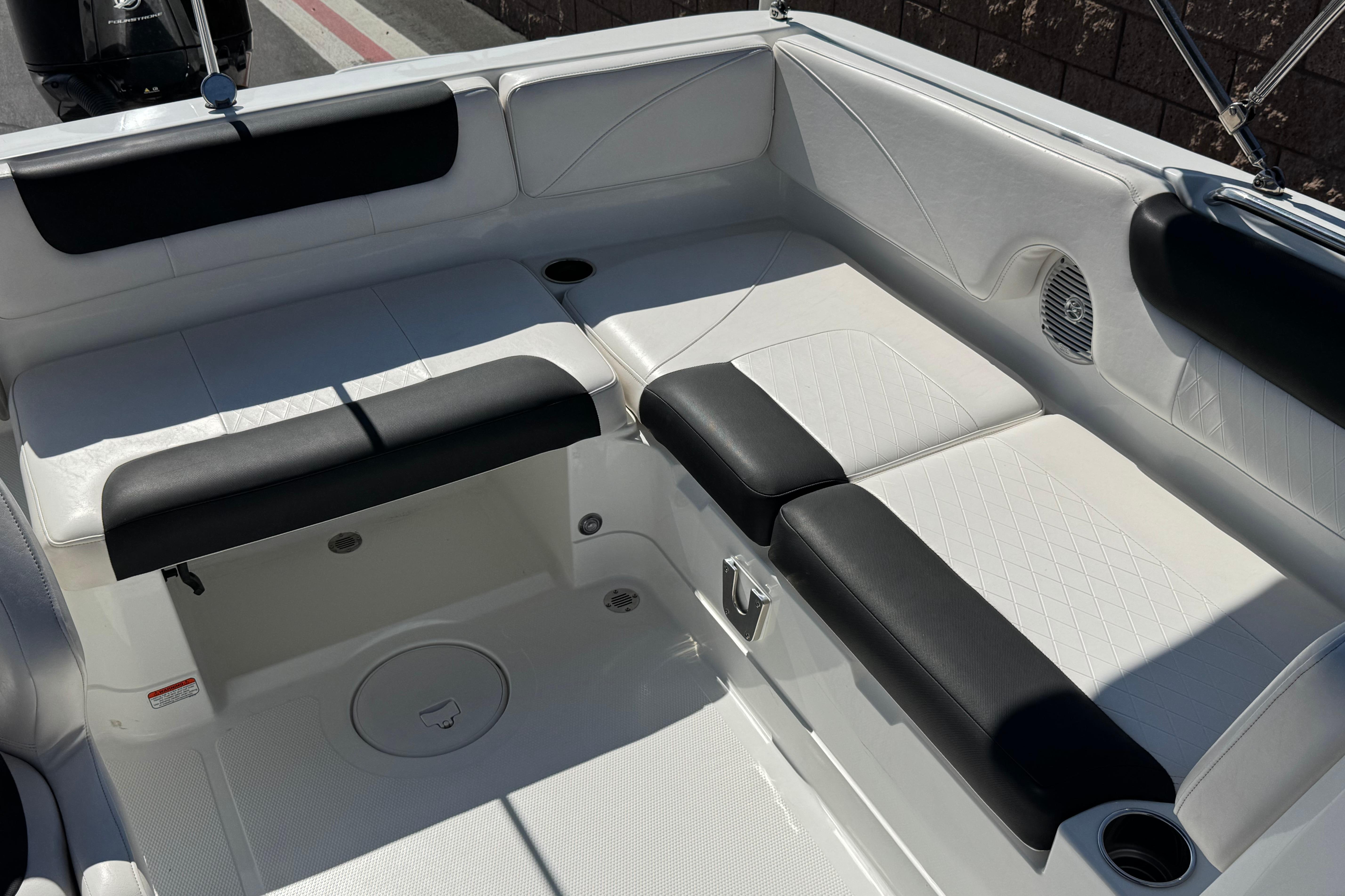 2019 Tahoe 2150 boat interior with white and black seating, cup holder, and speaker.