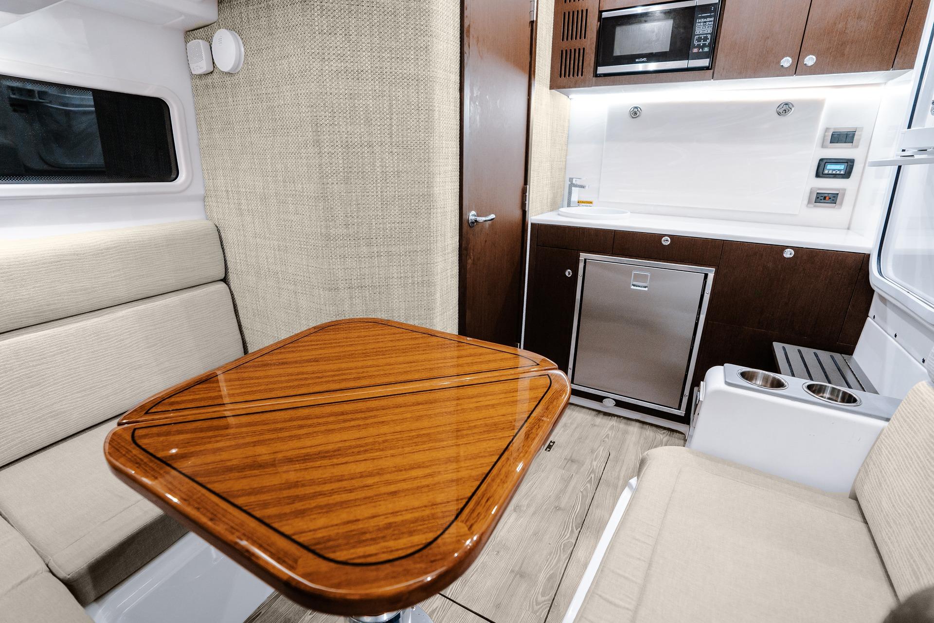 Interior of 2026 Everglades 455 Center Console boat with modern kitchen and seating area.