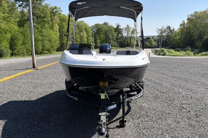2026 Tahoe T16 boat on trailer, parked on a road with trees in the background.