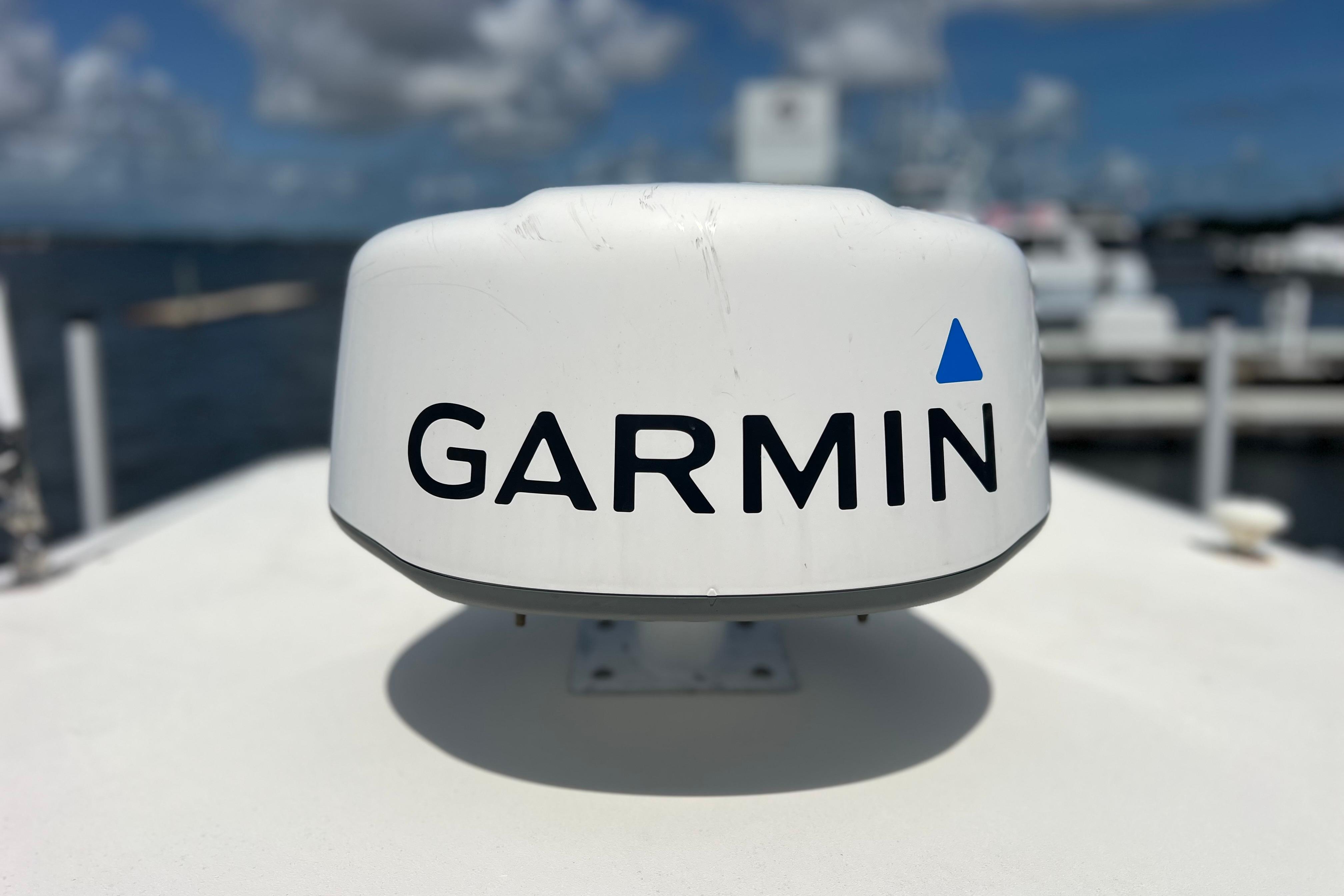 Garmin radar on 2004 Pursuit 2870 Walkaround boat, docked with cloudy sky background.
