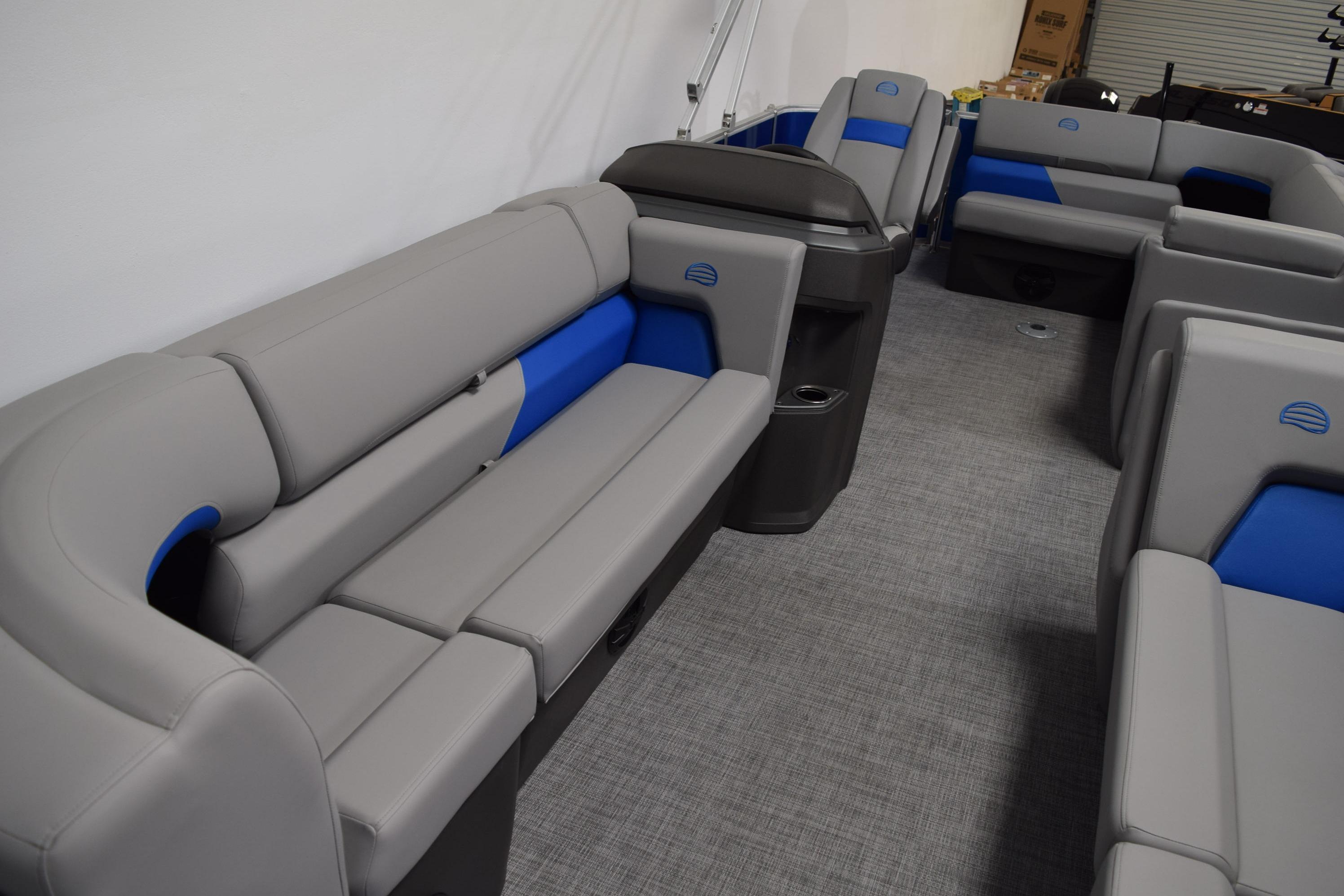2026 Sun Tracker Party Barge 20 DLX interior with gray and blue seating.