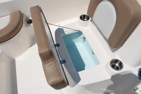 2023 Sundance DX20 boat interior with open storage compartment and cup holders.
