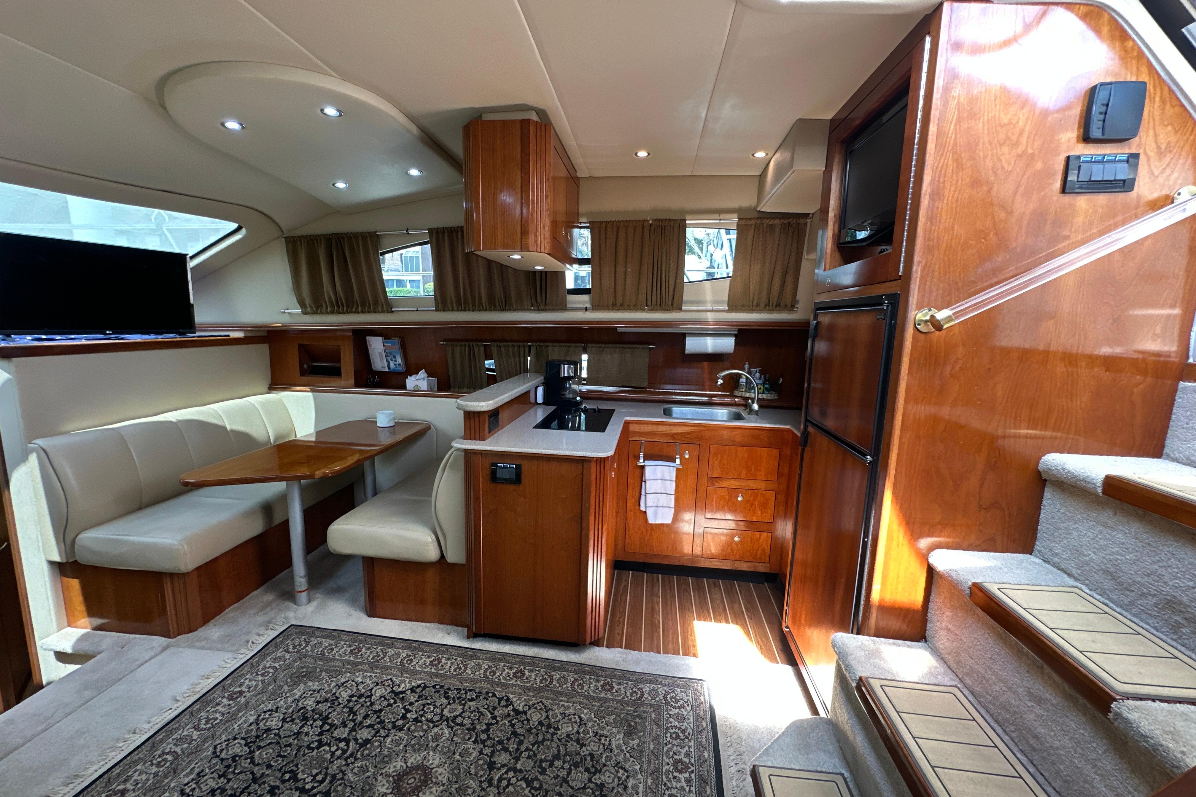 Luxurious interior of 2004 Cruisers Yachts 405 Express Motoryacht with kitchen and dining area.
