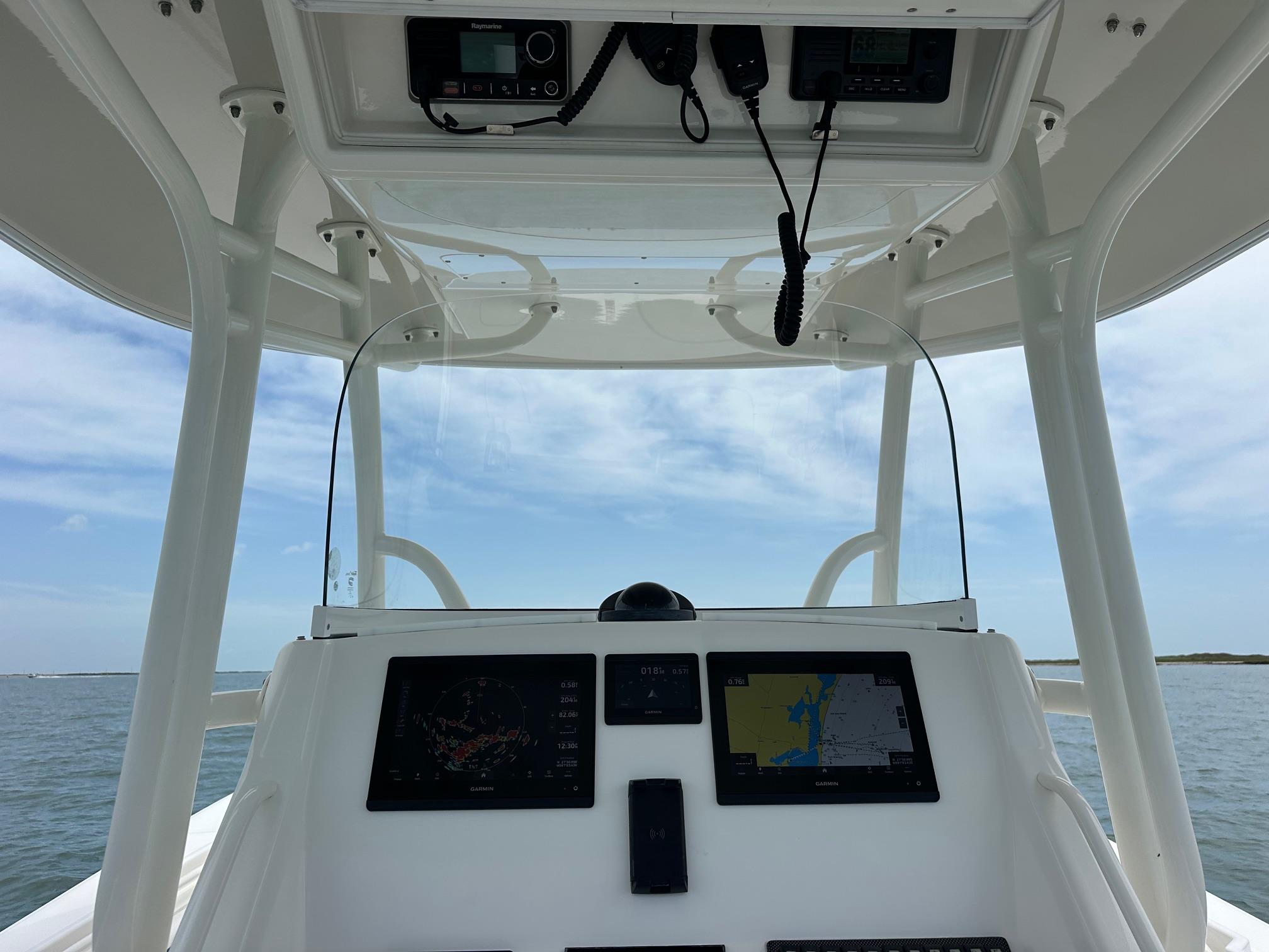2016 Regulator center console boat with navigation equipment, open sea view.