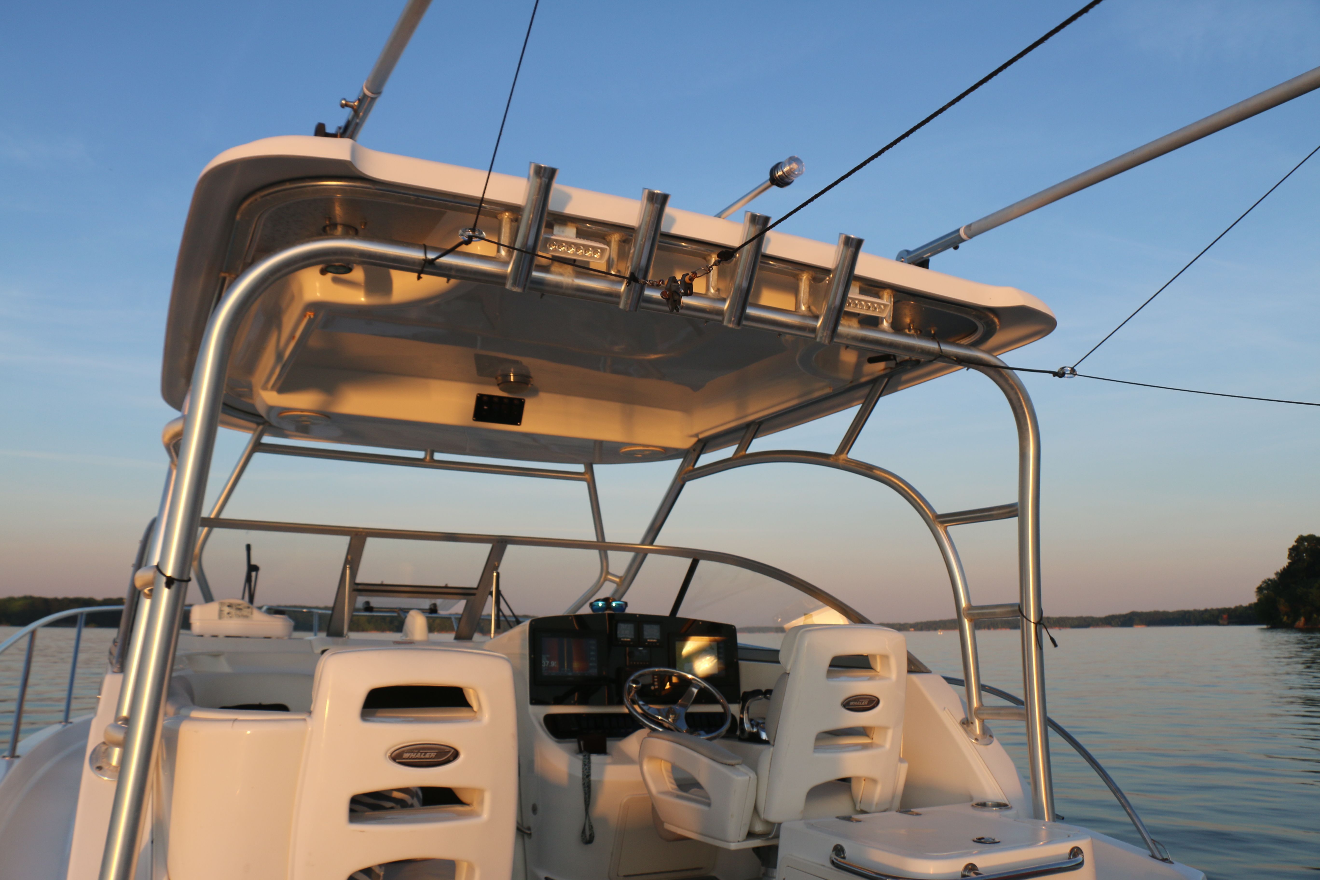 The image shows the cockpit of a 2006 Boston Whaler 305 Conquest on calm water.