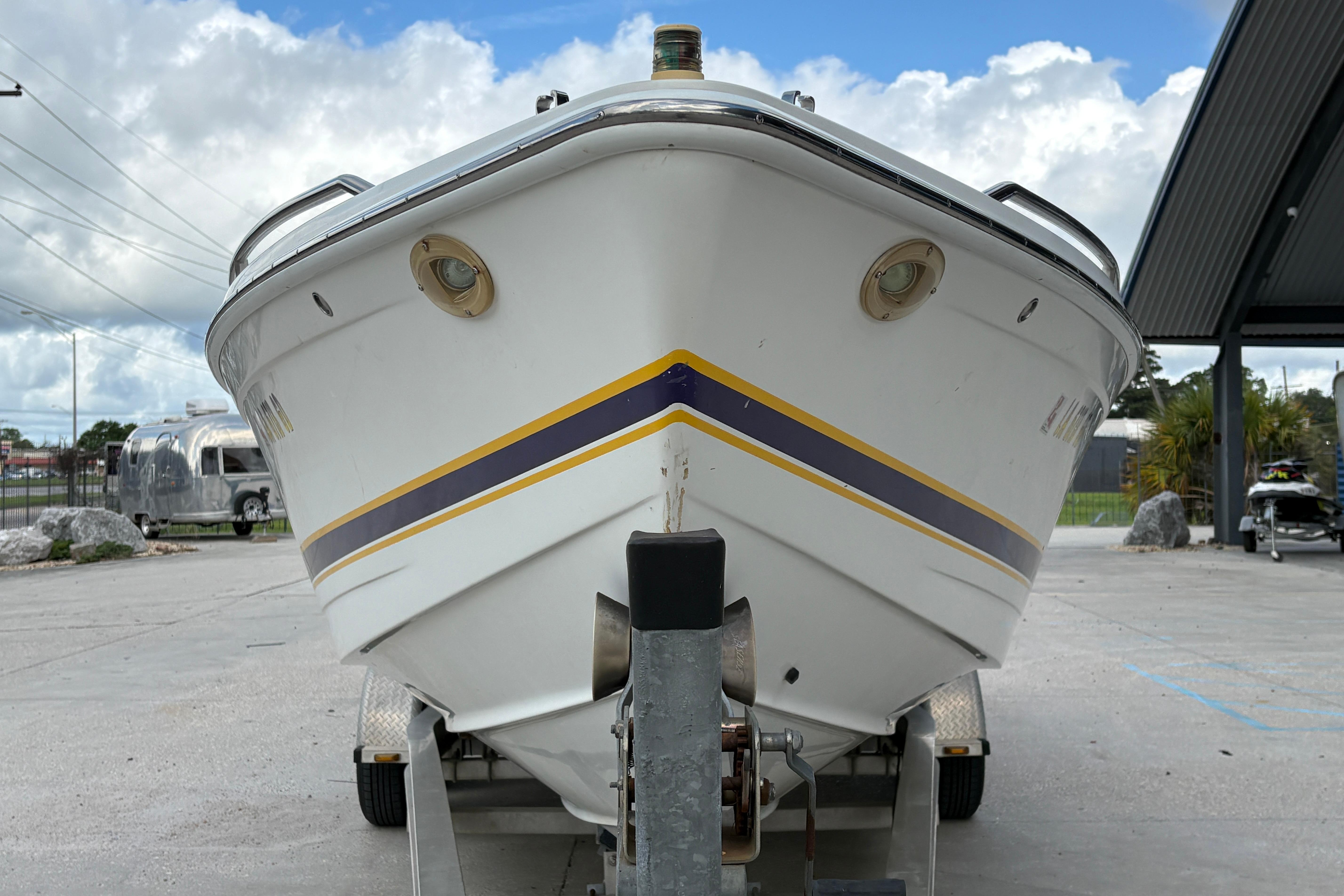 2002 Formula 292 FASTech boat on trailer, front view, under cloudy sky.