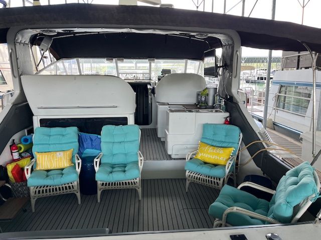 The image shows the cockpit of a 1989 Trojan 370 Express with blue chairs and cushions.