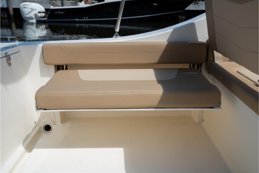 2023 Scout 240 Dorado boat with tan cushioned seating.