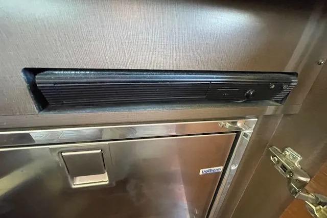 2016 Sea Ray Sundancer 510 interior detail with stainless steel appliance and wood finish.