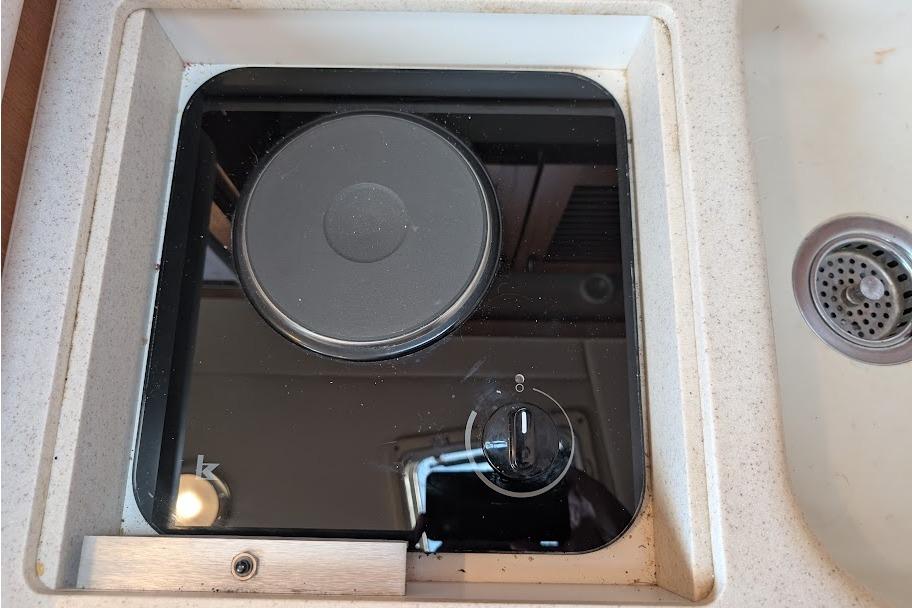 Electric stove on a 2000 Pursuit 3400 Express boat, next to a sink.
