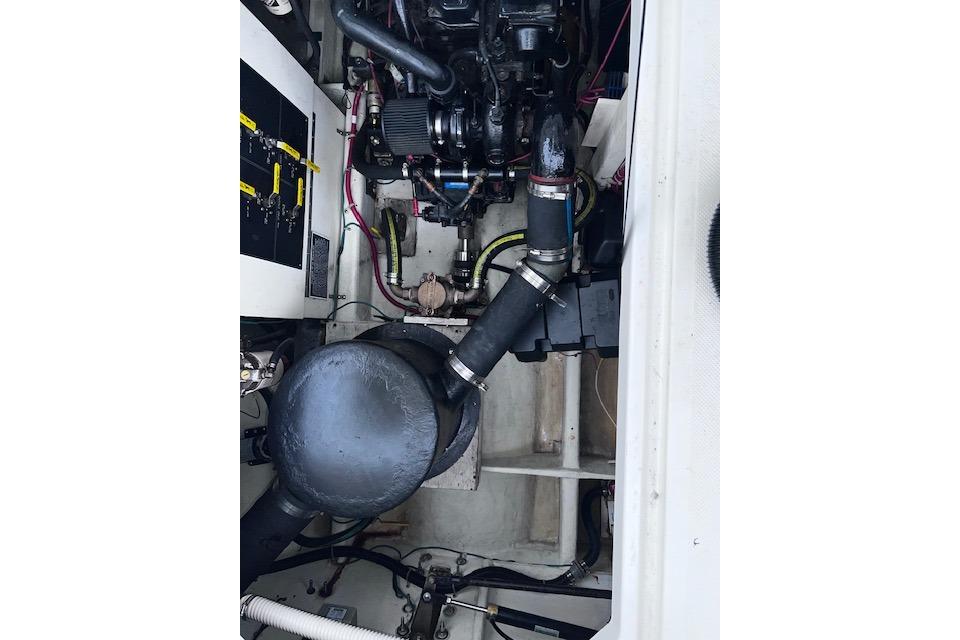 Engine compartment of a 1996 Bayliner 3388 Command Bridge Motoryacht, showcasing mechanical components.