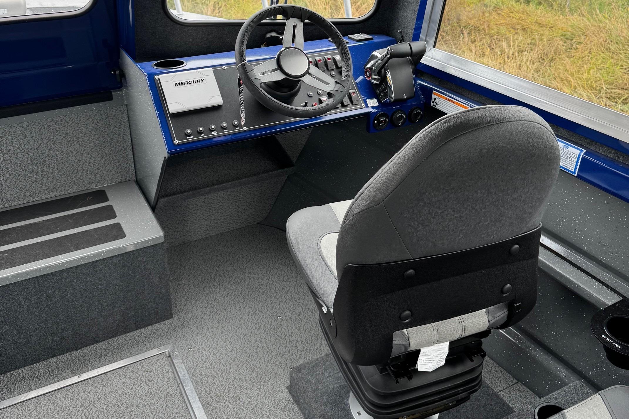 2024 Spartan 26 Maximus Pro XL boat interior with steering wheel and captain's chair.