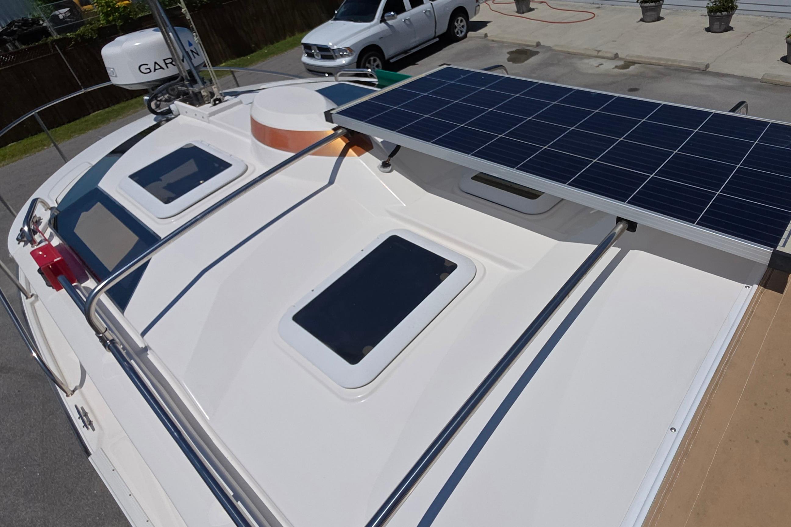 2021 Ranger Tug R27 boat with solar panels and rooftop features.