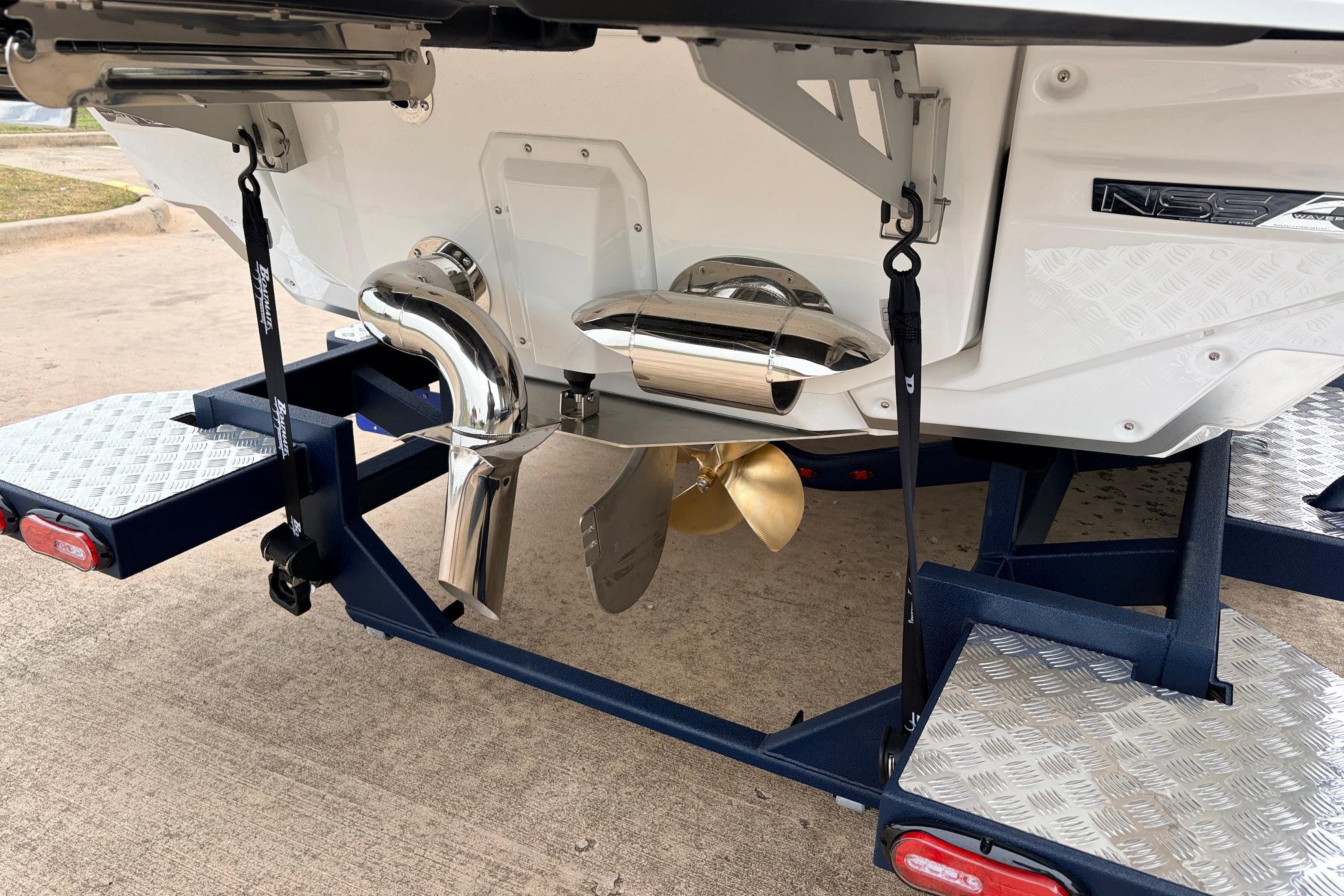 2026 Nautique Super Air Nautique G25 boat on trailer, showcasing propeller and exhaust system.