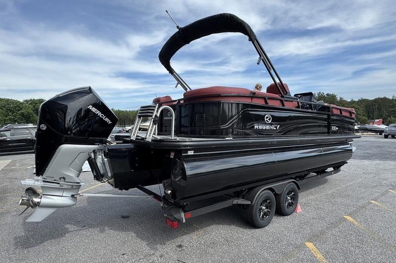 2026 Regency 230 DL pontoon boat on trailer with Mercury outboard motor.