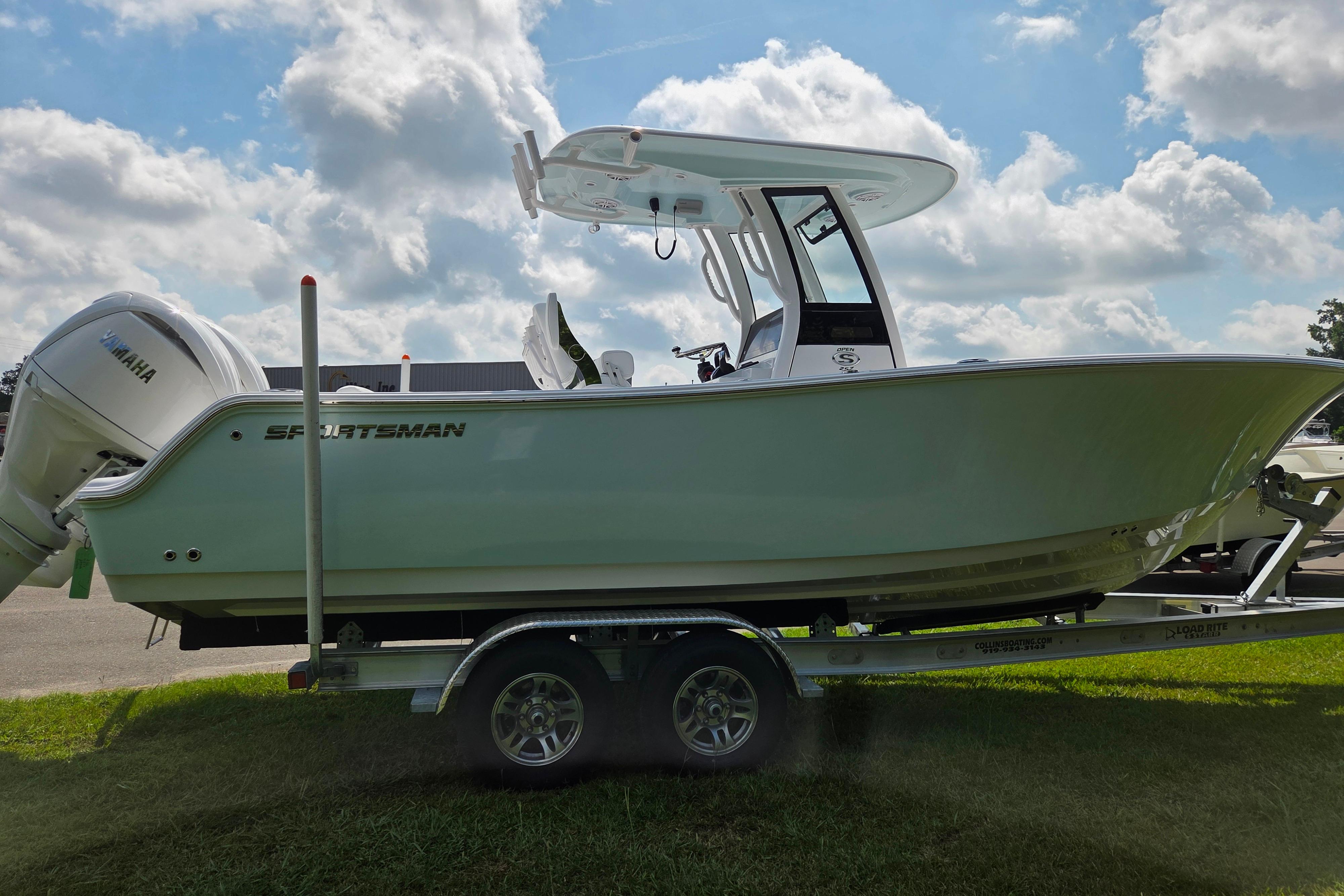 2026 Sportsman Open 252 Center Console boat on trailer under cloudy sky.