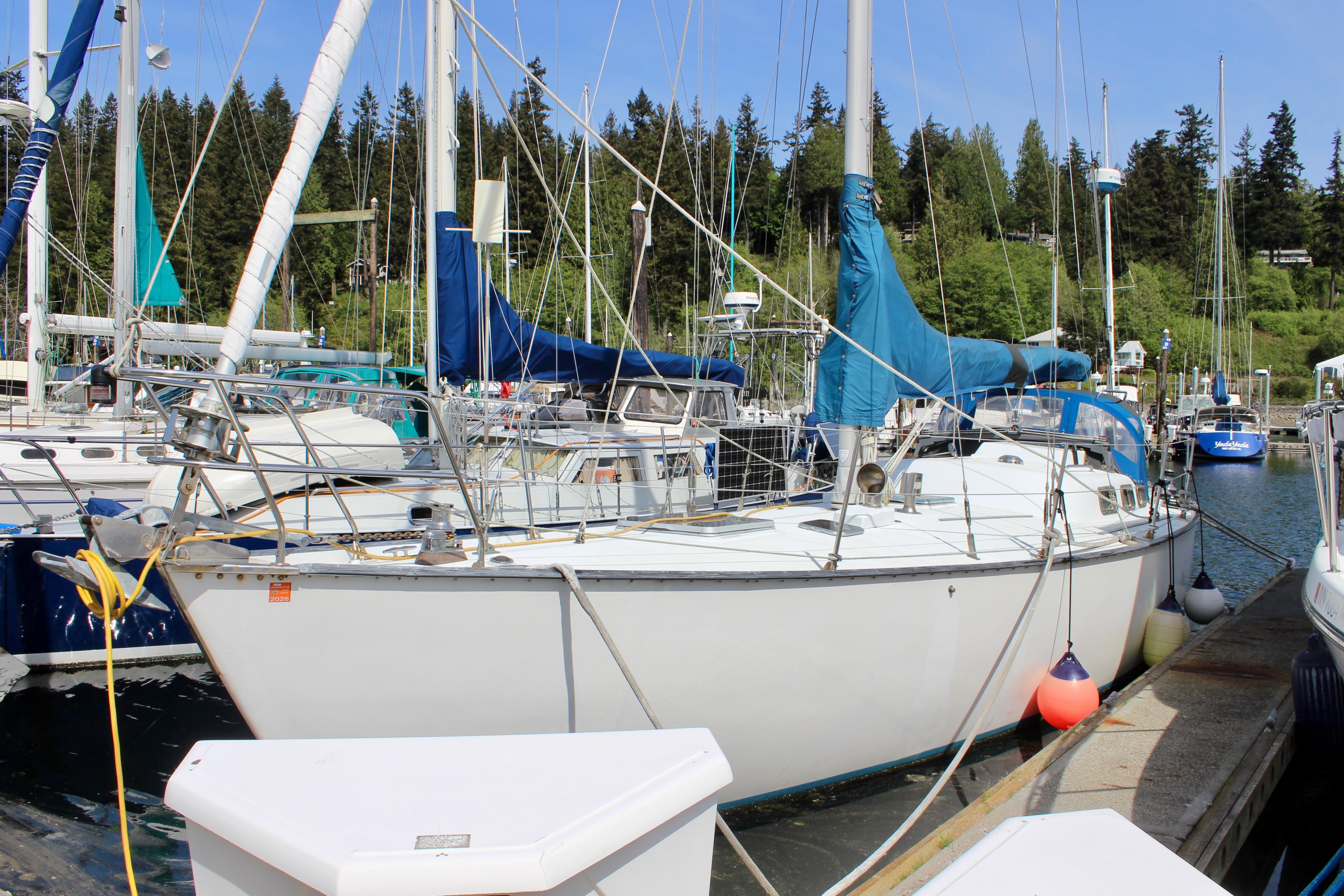 Sailboat Freya 39, 1993 model, docked at marina with forested background.