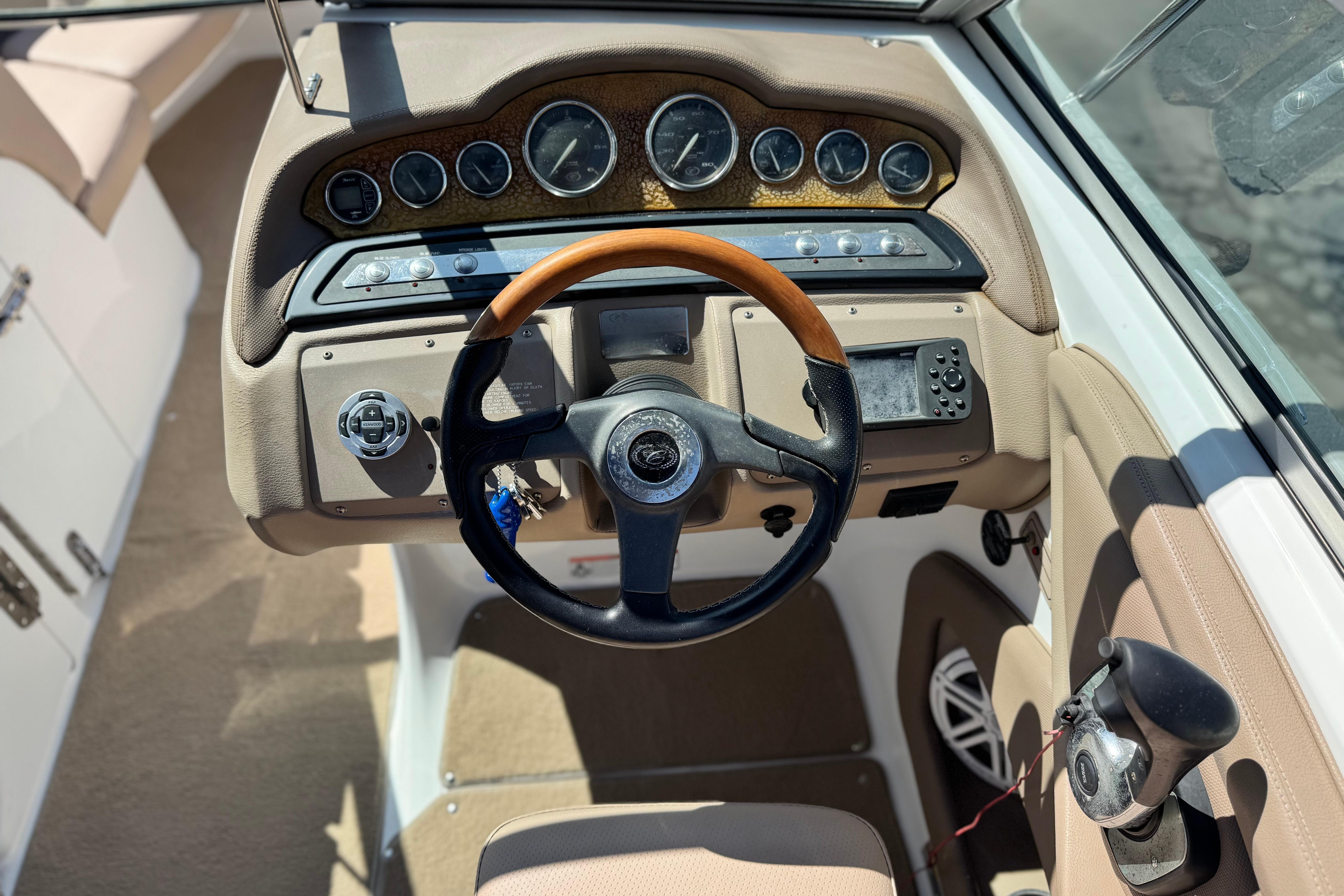 2008 Cobalt 262 boat dashboard with steering wheel and control panel.