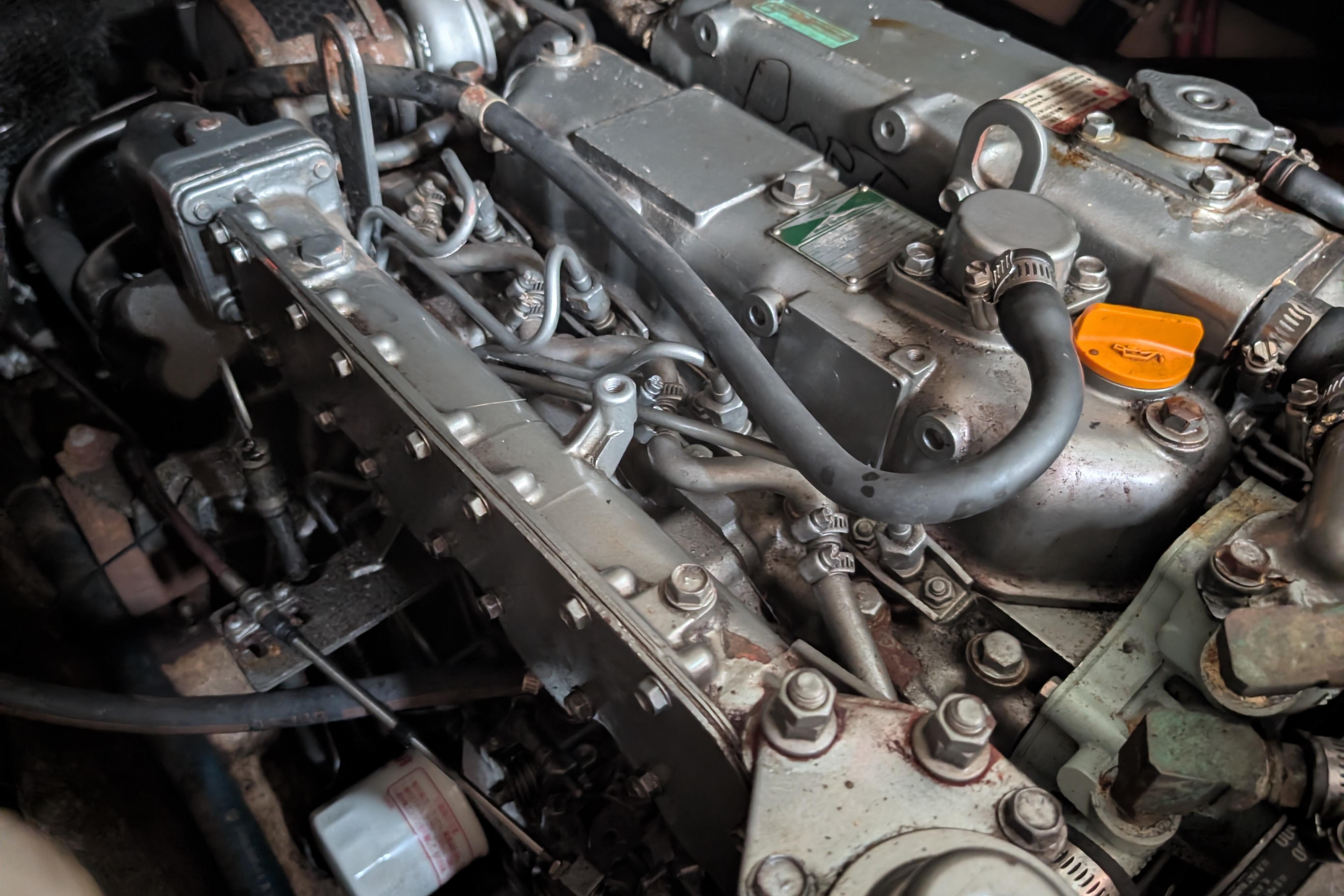 Engine of a 2004 PDQ 34 Powercat, showcasing intricate mechanical components.