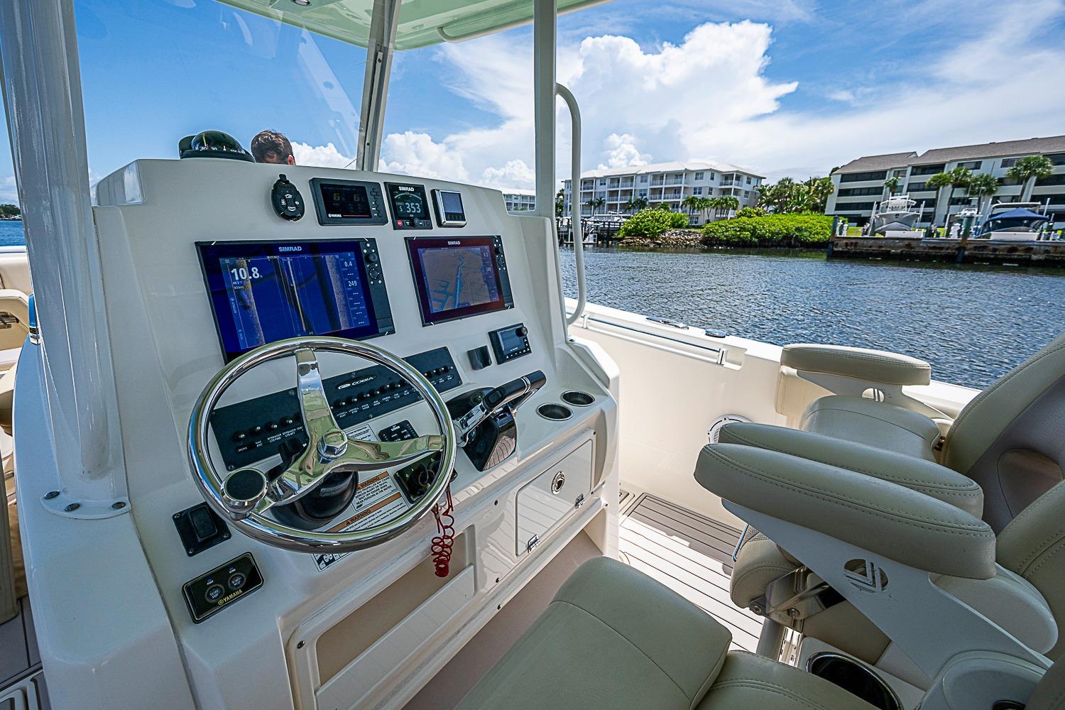 2019 Cobia 320 Center Console helm with dual displays and luxurious seating.