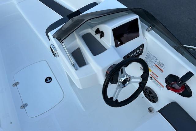 2026 Tahoe T16 boat dashboard with steering wheel and control panel.