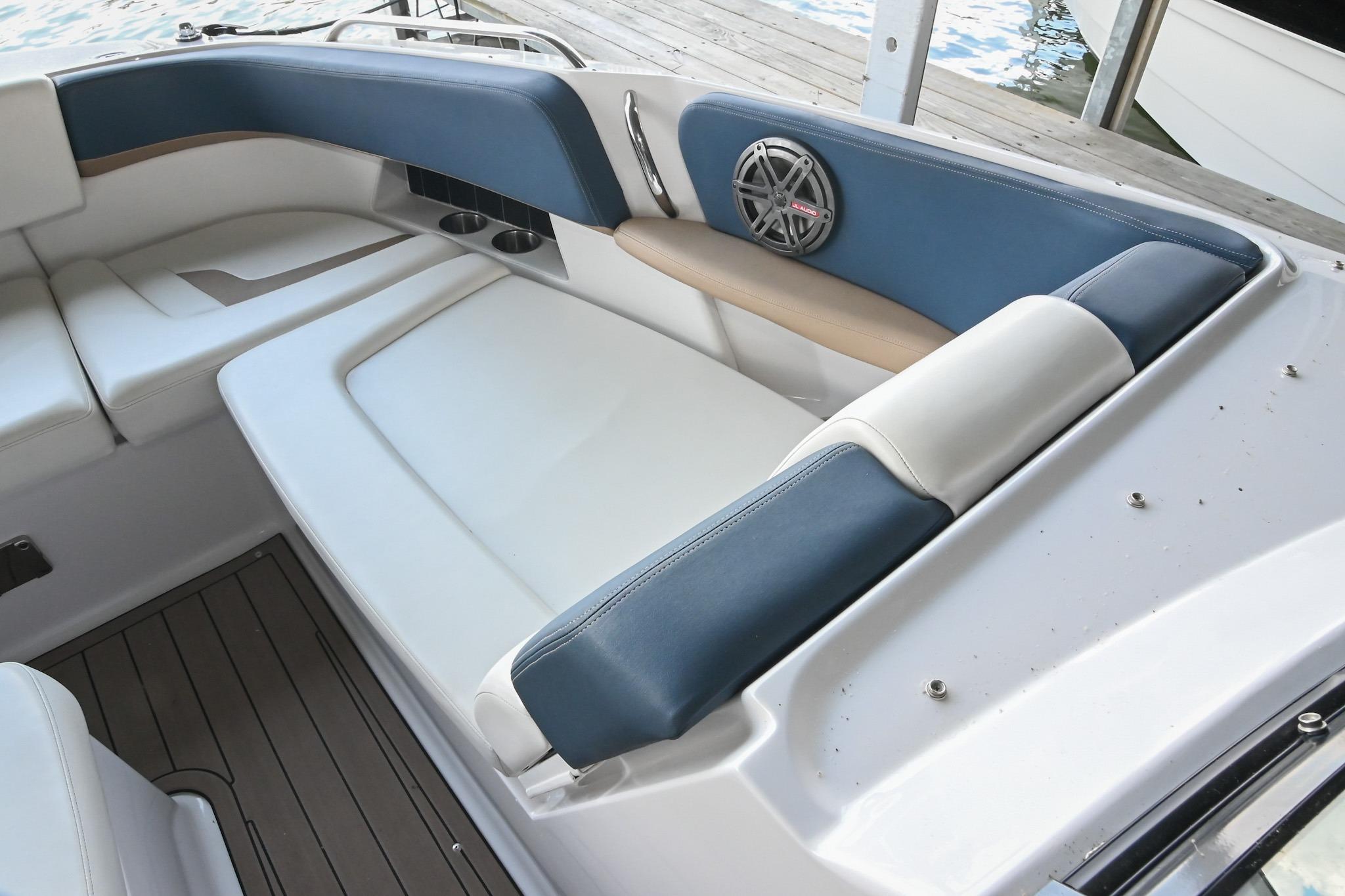 Interior seating of a 2014 Four Winns H290 boat with blue and white upholstery.