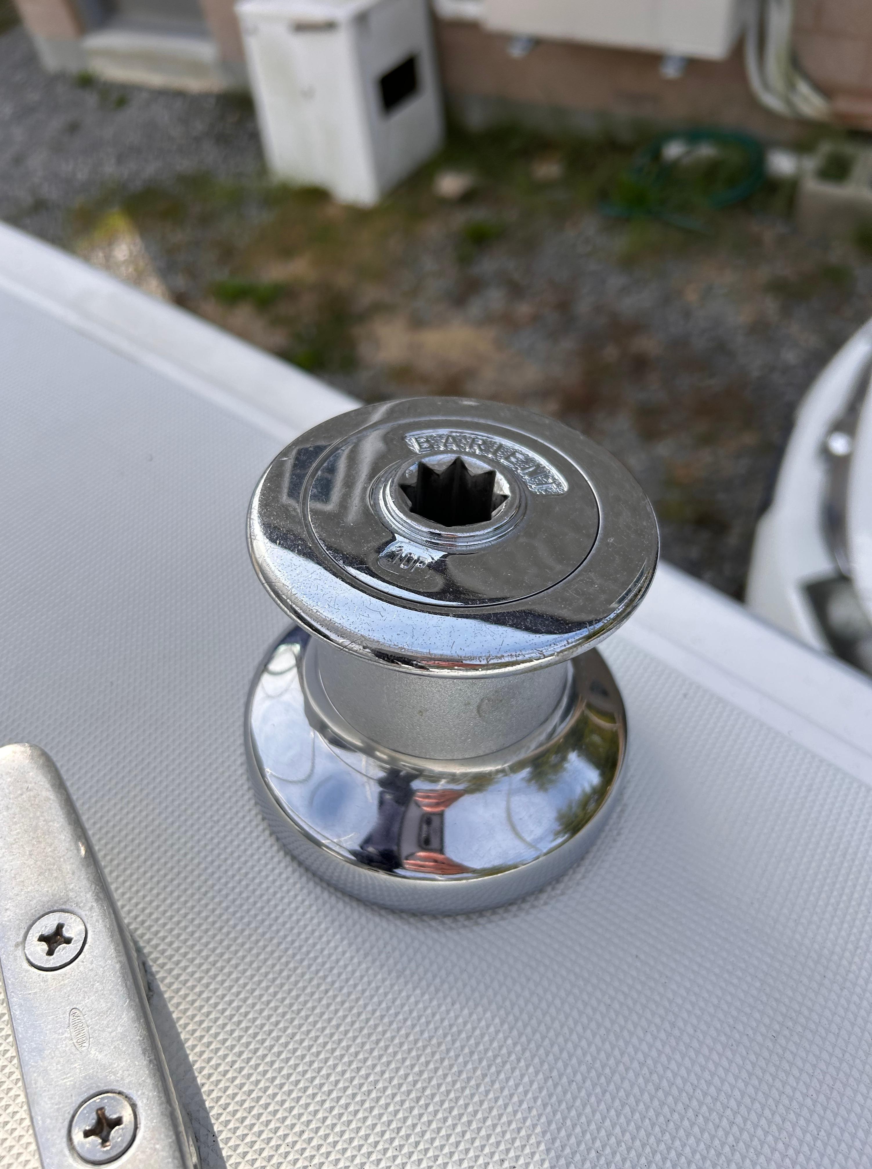 Chrome winch on a 1986 CAL 22 sailboat deck.