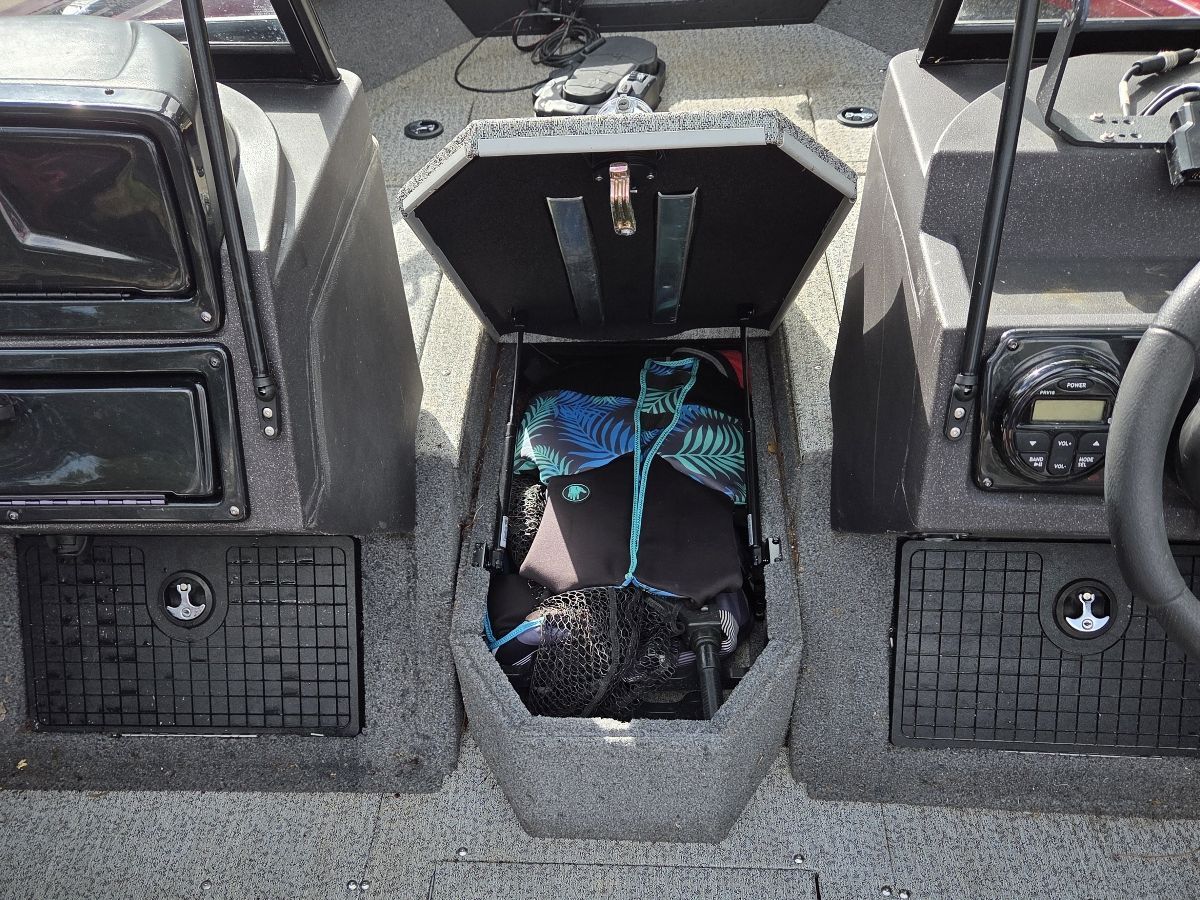 Interior of a Tracker Targa V-19 TE boat, storage compartment open.