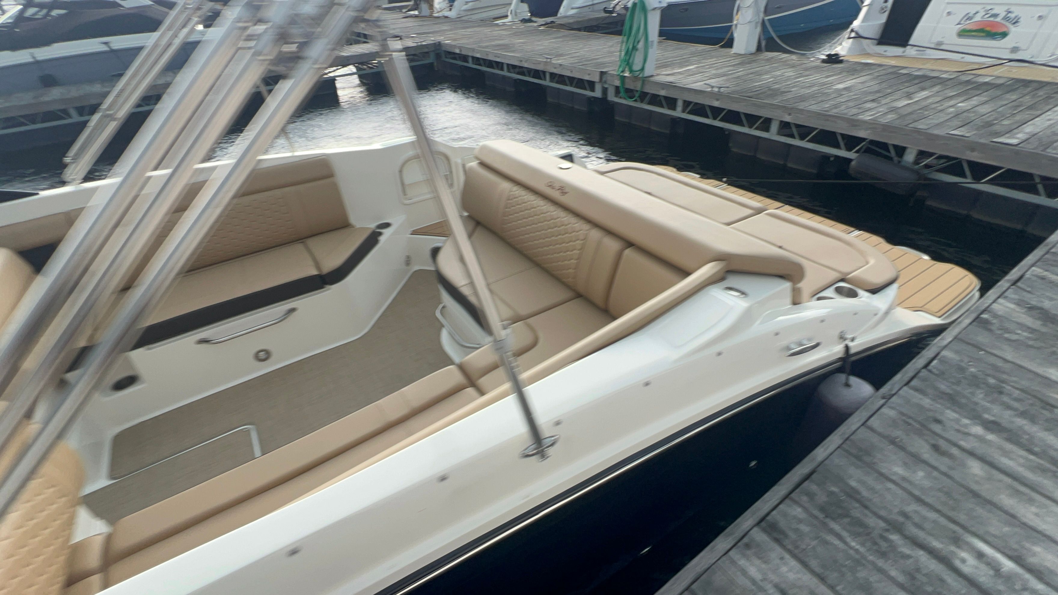 2018 Sea Ray SDX 270 boat docked with beige seating.