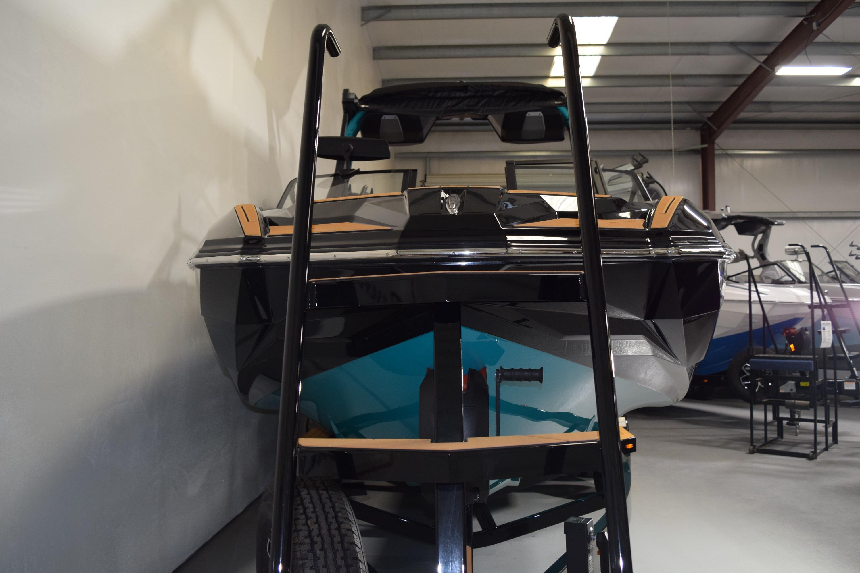 2026 Supra SL 550 boat in showroom, front view with trailer.