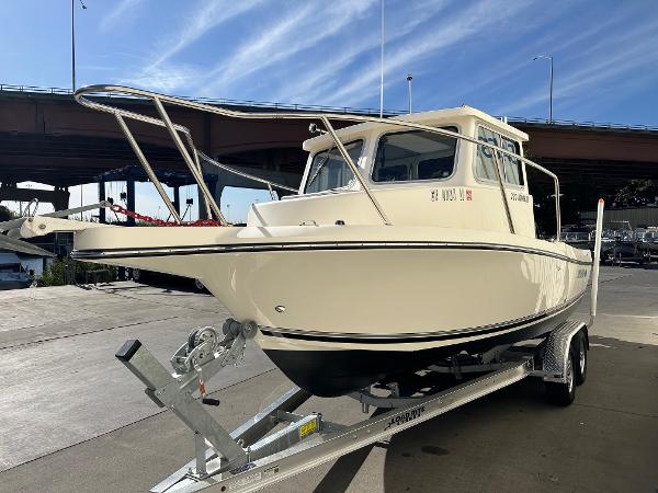 2023 Defiance Admiral 220 EX boat on trailer under clear sky.