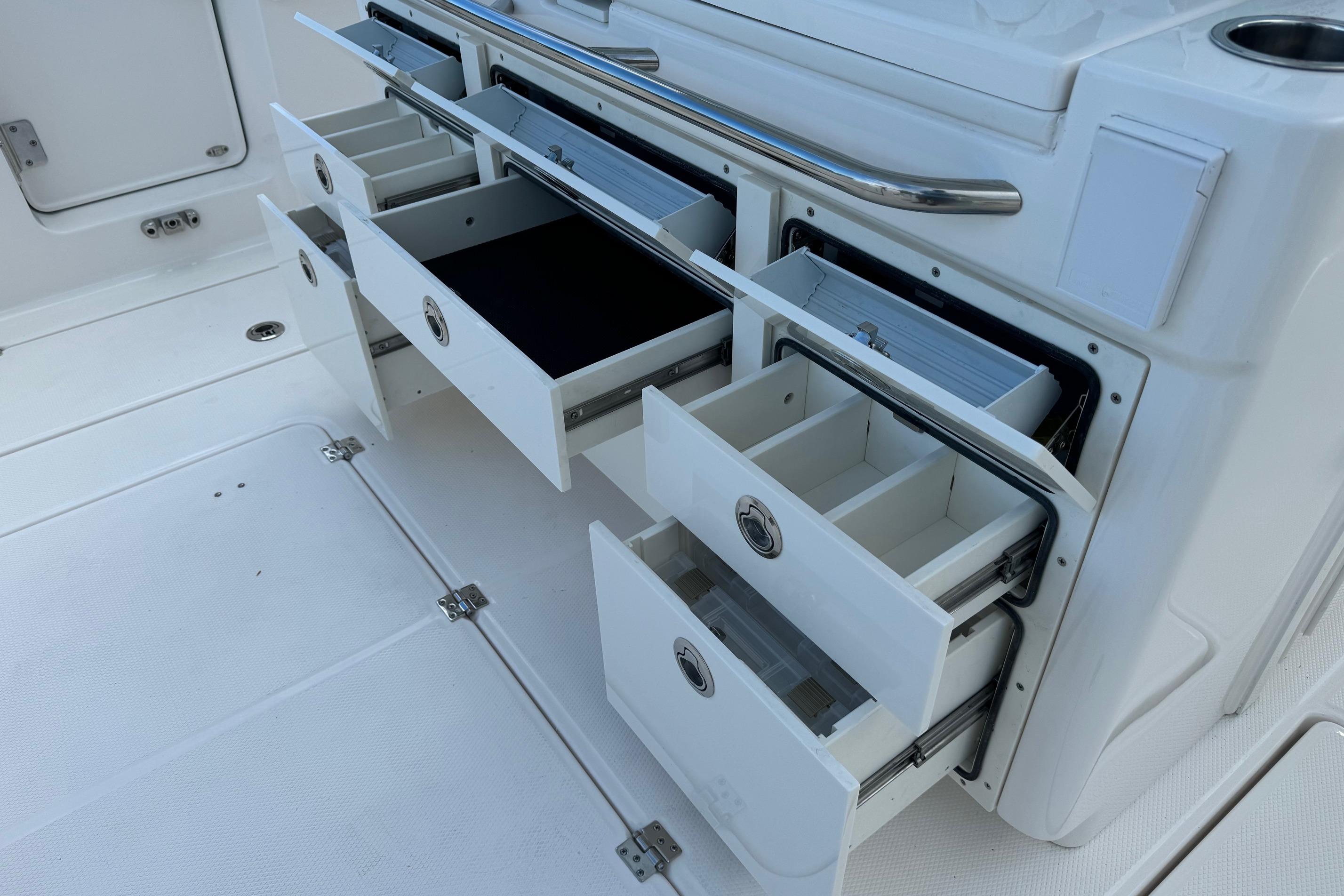 Open storage drawers on a 2025 Robalo R360 Center Console boat.
