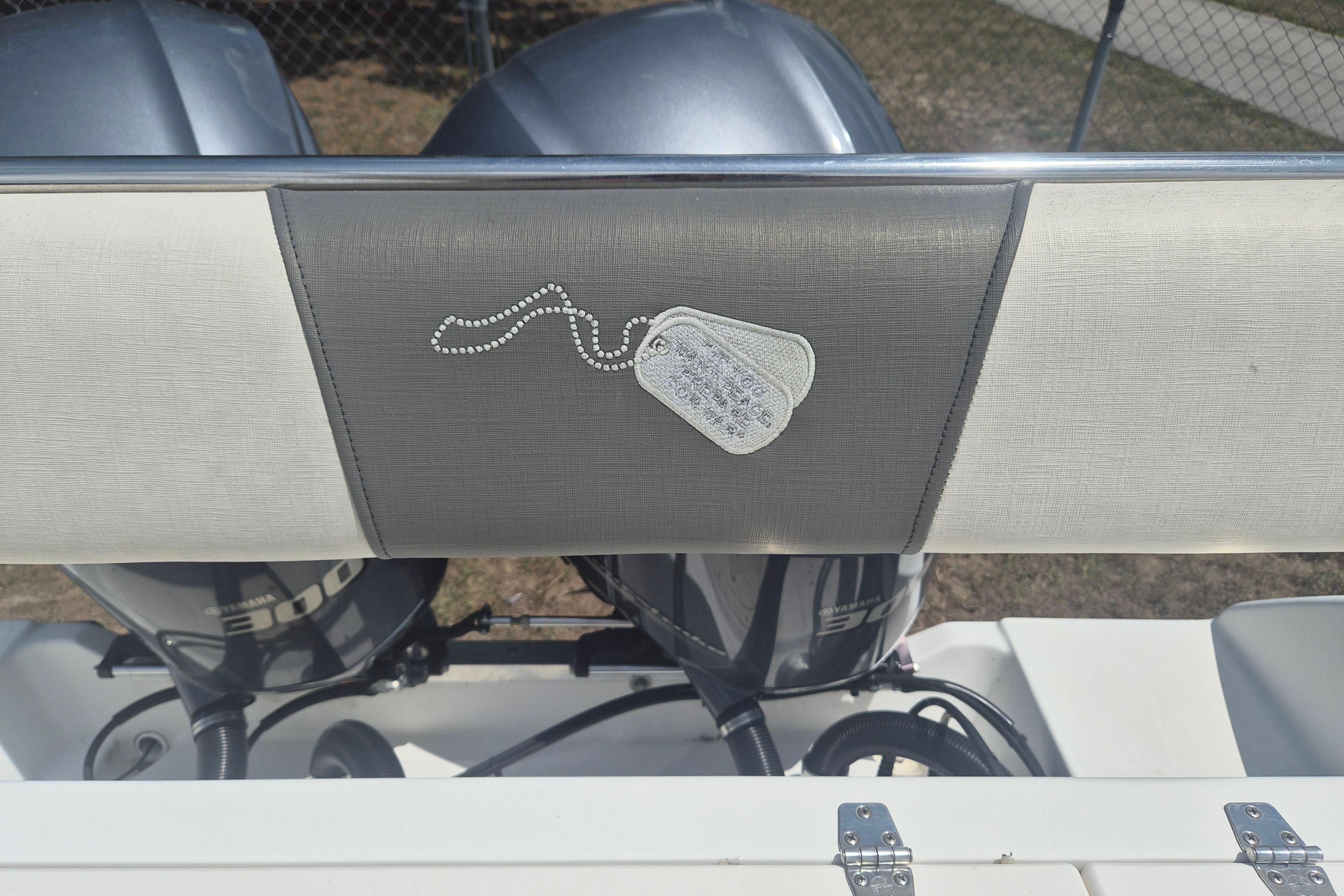 2006 Century 2900 Center Console boat with dual Yamaha engines, featuring a dog tag design on the seat.