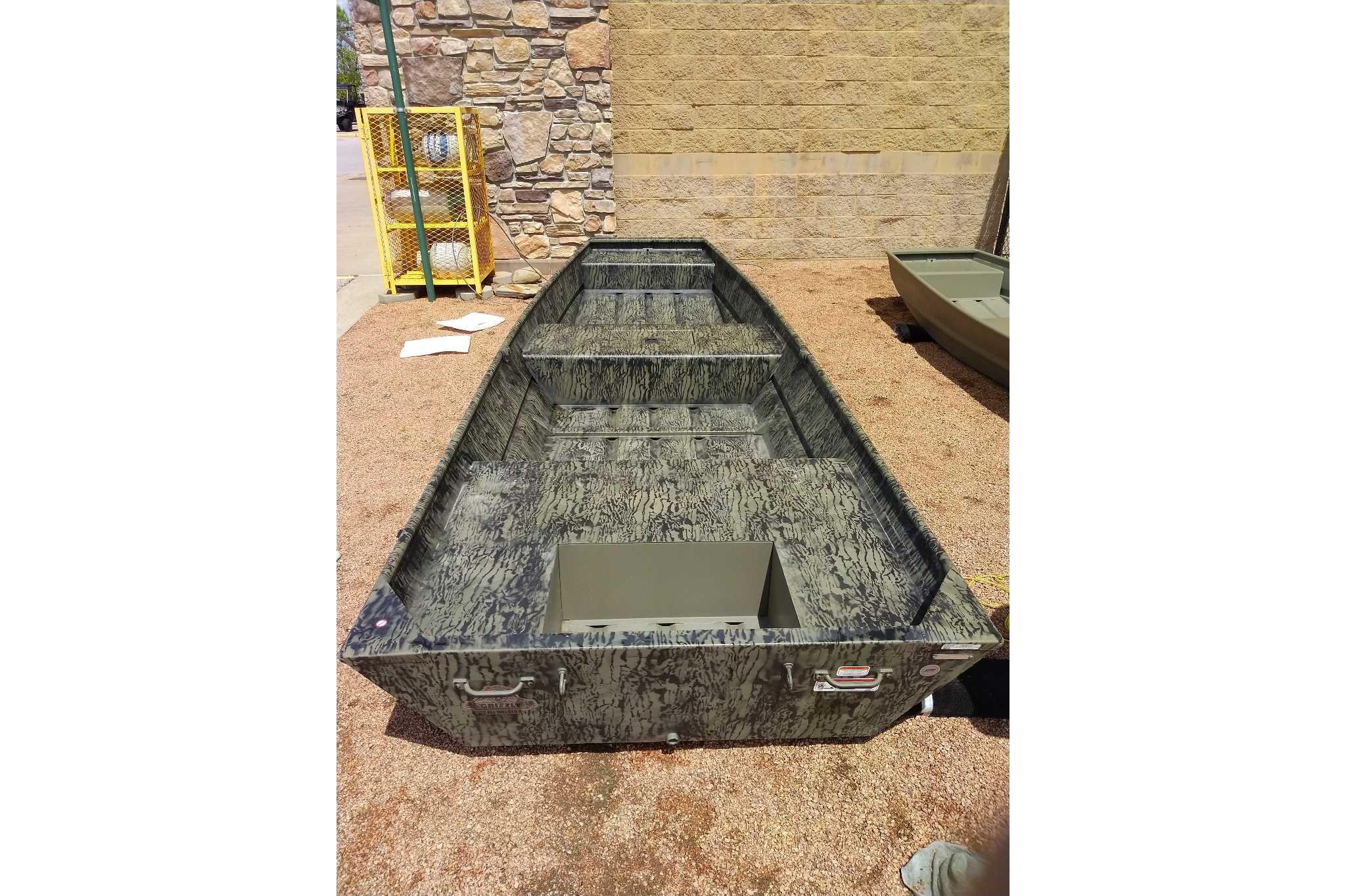 2026 Tracker Grizzly 15 Jon boat with camouflage design, displayed outdoors.