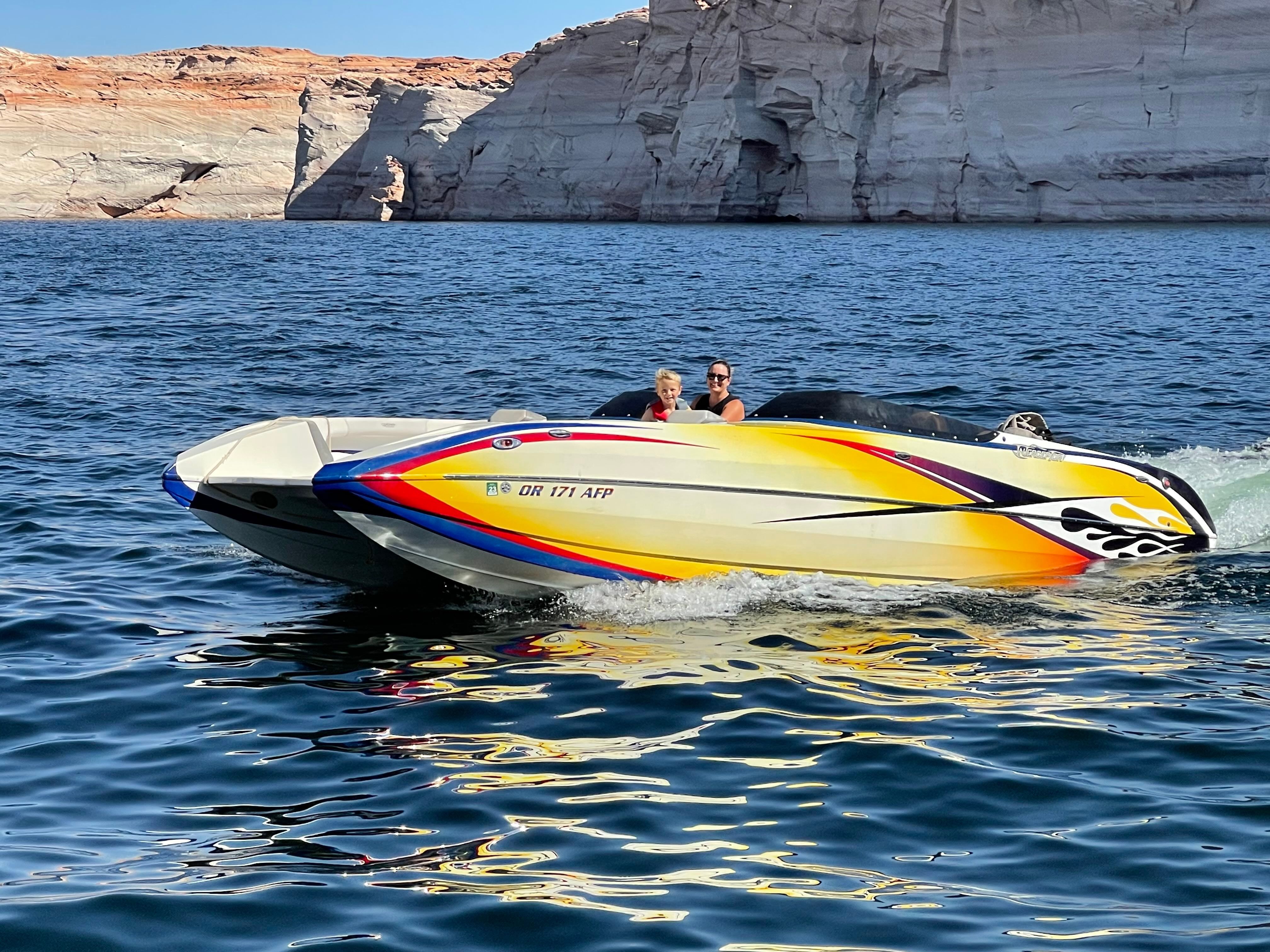 A 2016 Interceptor CoolCat cruising on a lake with rocky shores.
