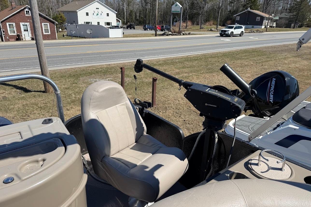 2013 Premier 221 Explorer boat interior with beige seating and Mercury motor.