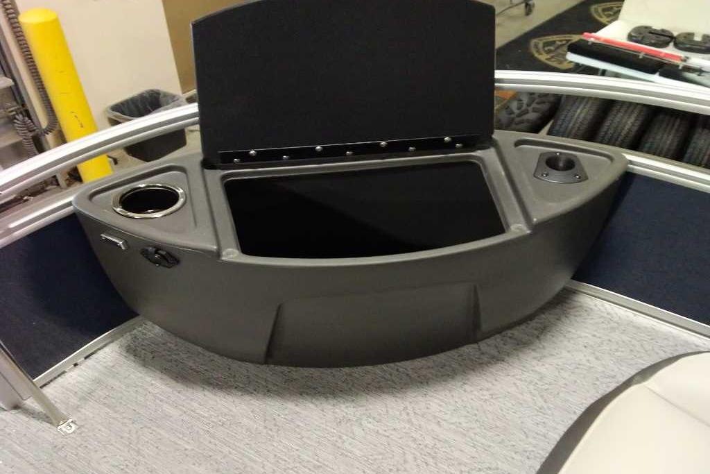2026 Sun Tracker Bass Buggy 18 DLX boat console with cup holder and storage compartment.