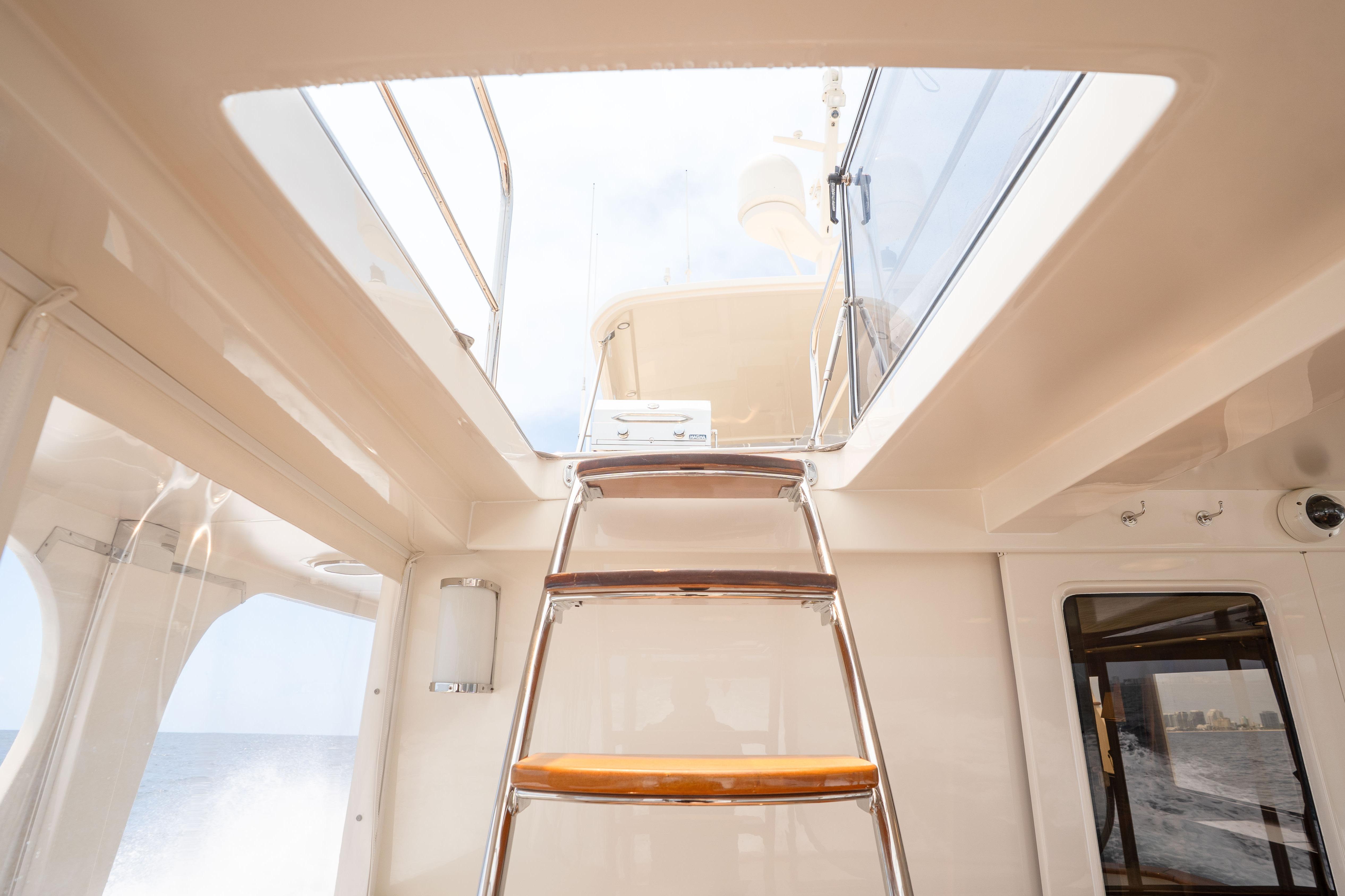 Interior view of 2006 Fleming 75 yacht with ladder to upper deck.