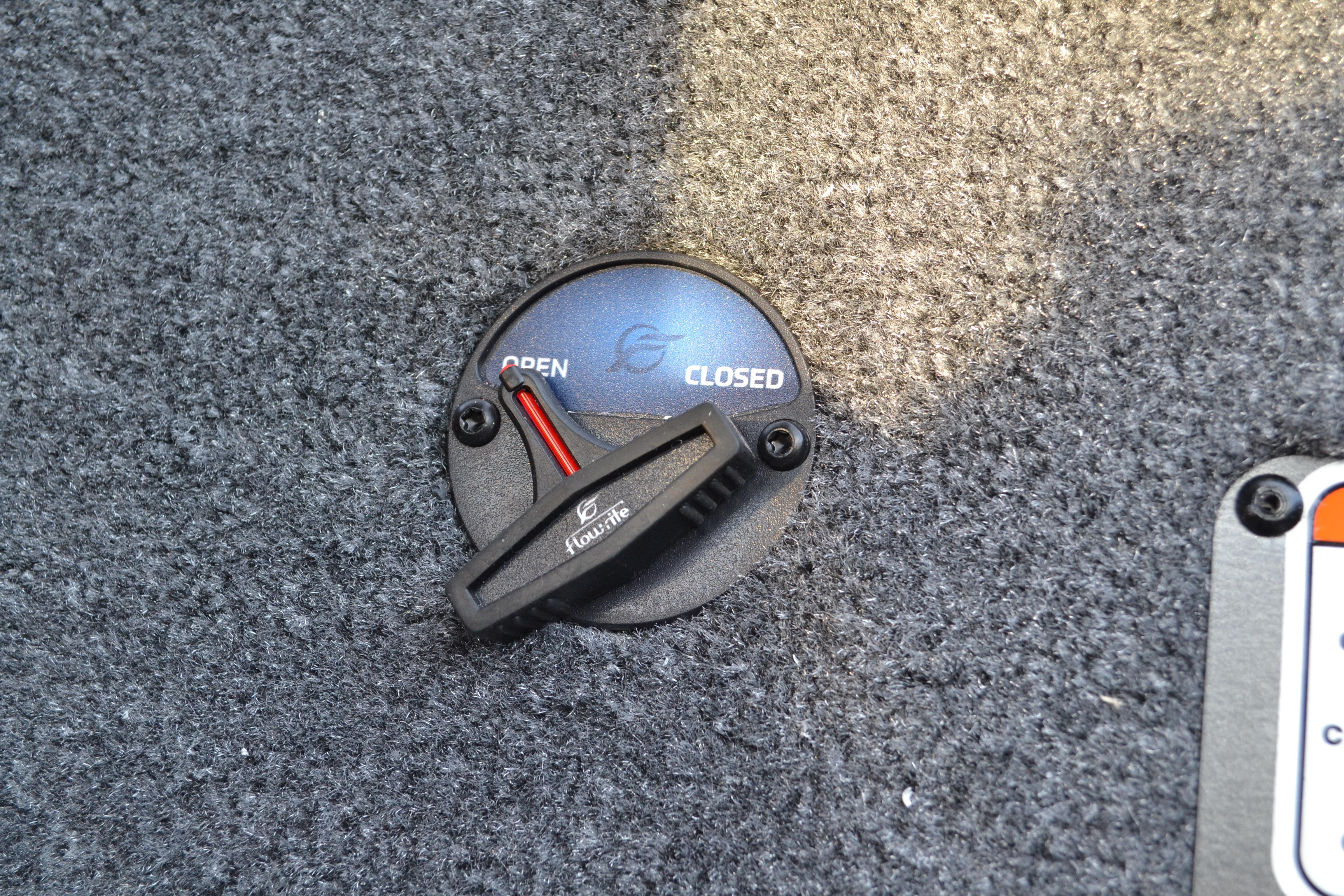 2026 Ranger RT188 Flow-Rite valve on carpeted surface, showing open and closed positions.