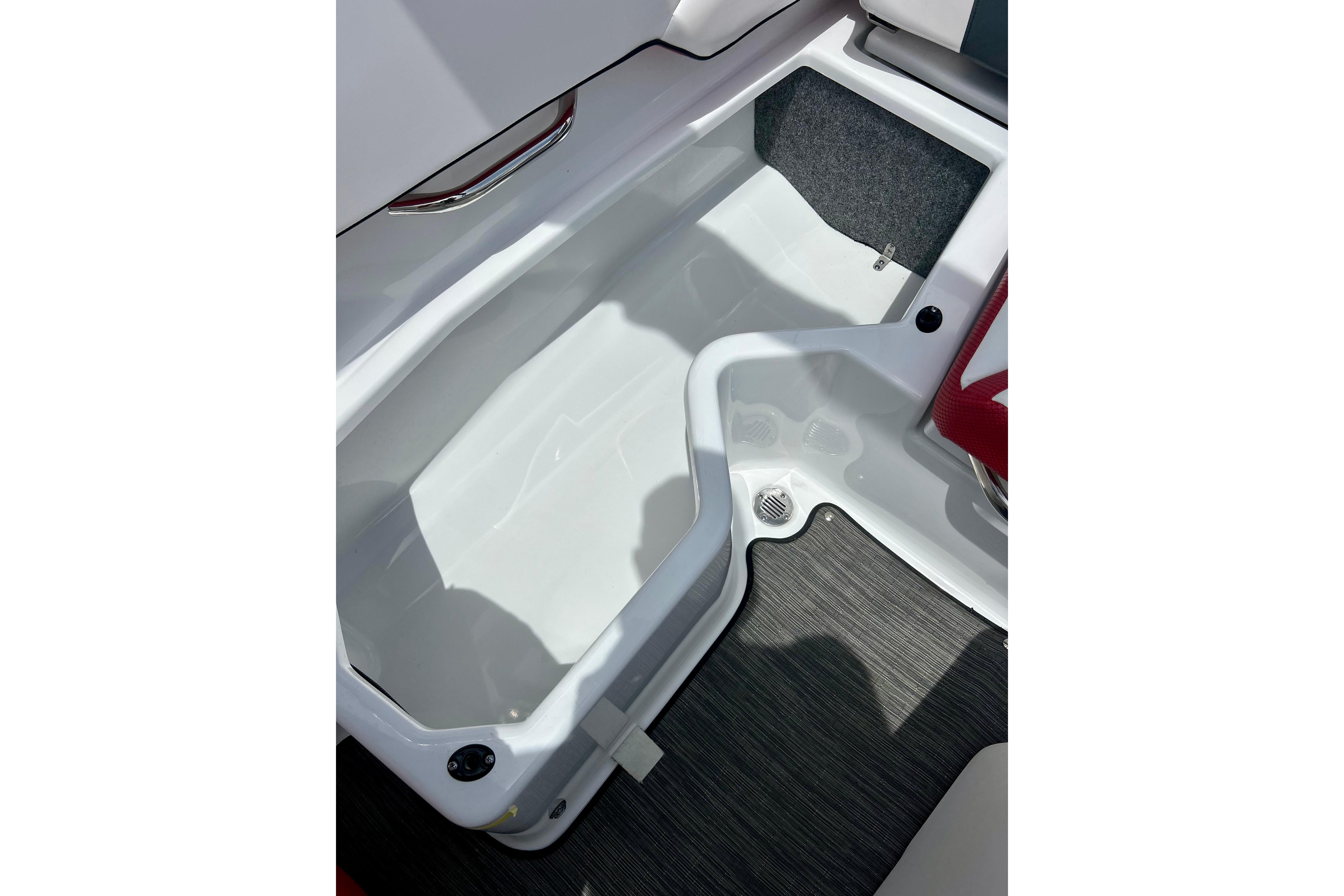 Interior storage compartment of 2021 Scarab 195 ID boat, featuring sleek design and ample space.