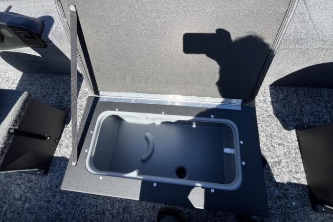 2025 Tracker Panfish 17 boat storage compartment with open lid, showcasing interior space.
