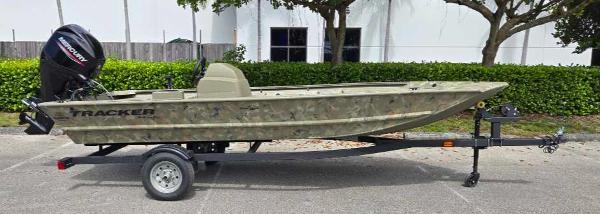 2025 Tracker Grizzly 1648 SC boat on trailer, parked outdoors.