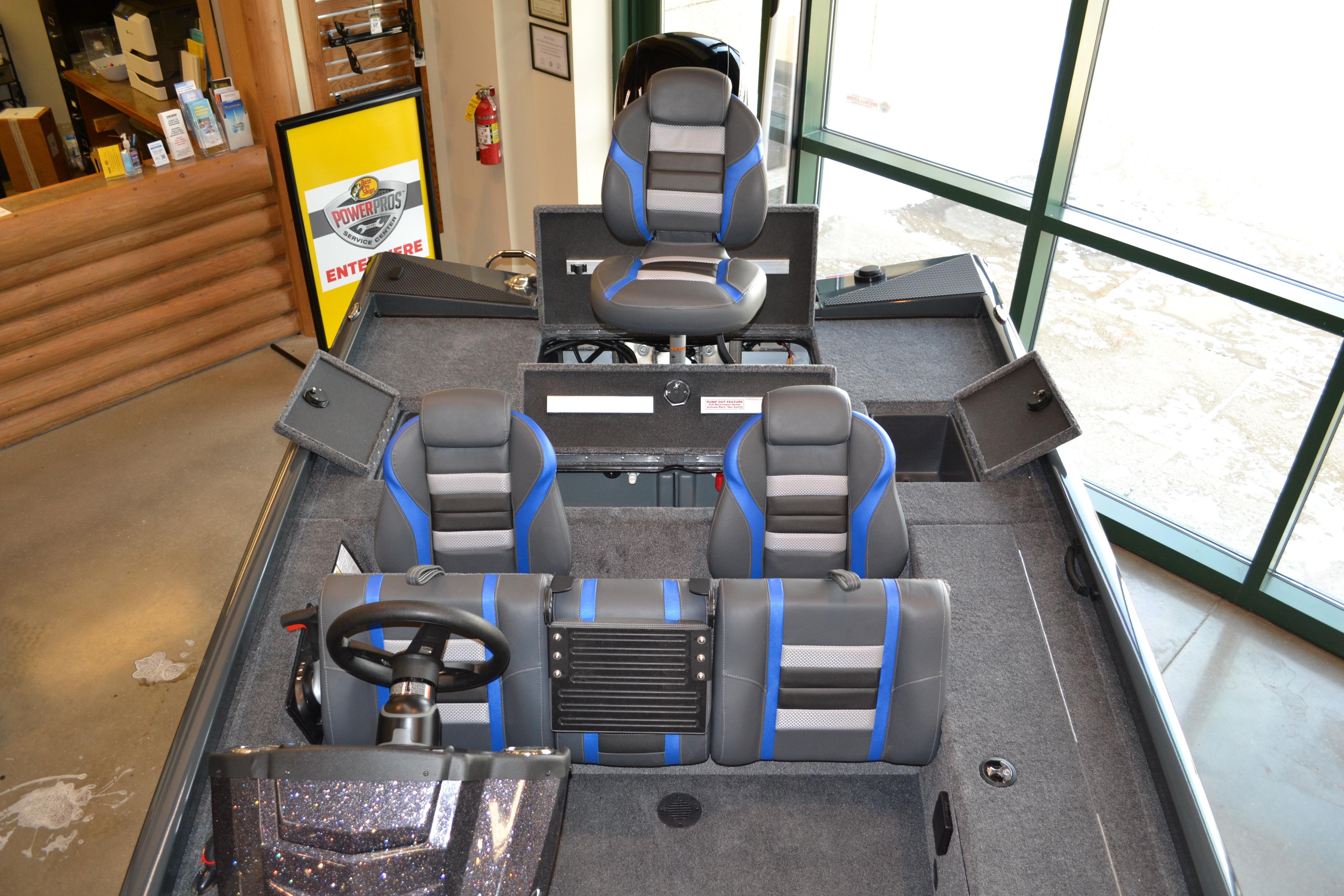2026 Ranger RT178C boat interior with blue and gray seating, steering wheel, and storage compartments.