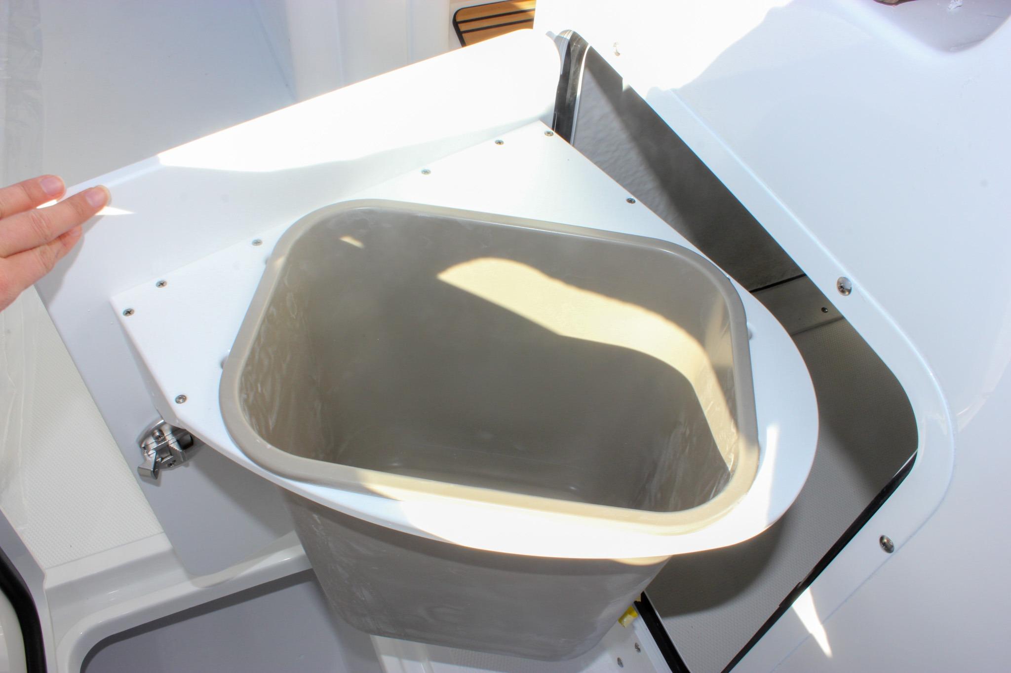 Storage compartment on 2026 Sea Hunt Ultra 285 SE boat, featuring a removable bin.