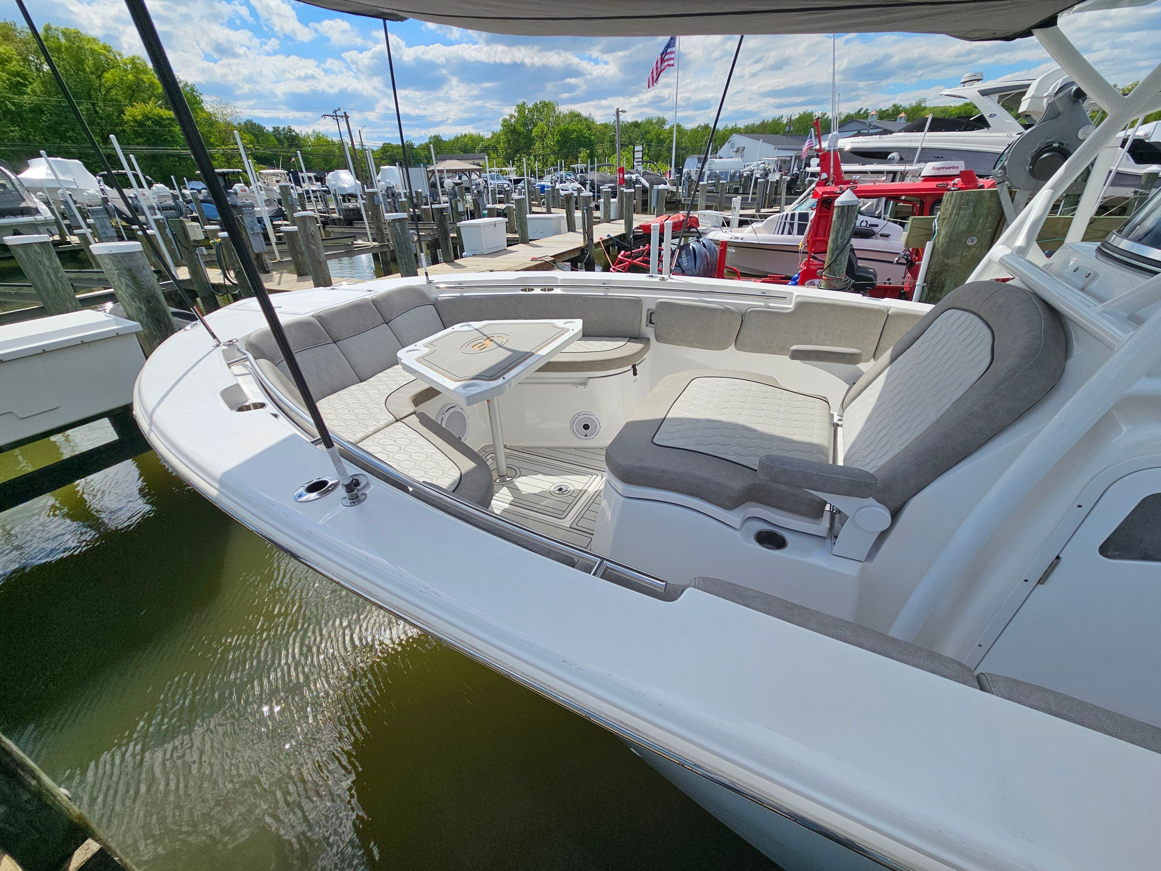 2021 Sea Fox 288 Commander boat at dock with seating area.